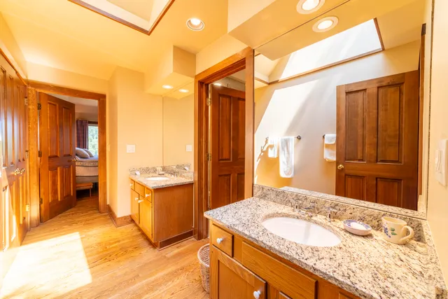 a room with lots of white furniture and a baby crib