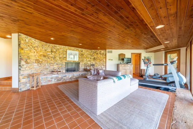 a yellow house with flower garden in front of it