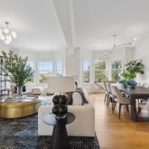 a living room with furniture a dining table and a fireplace