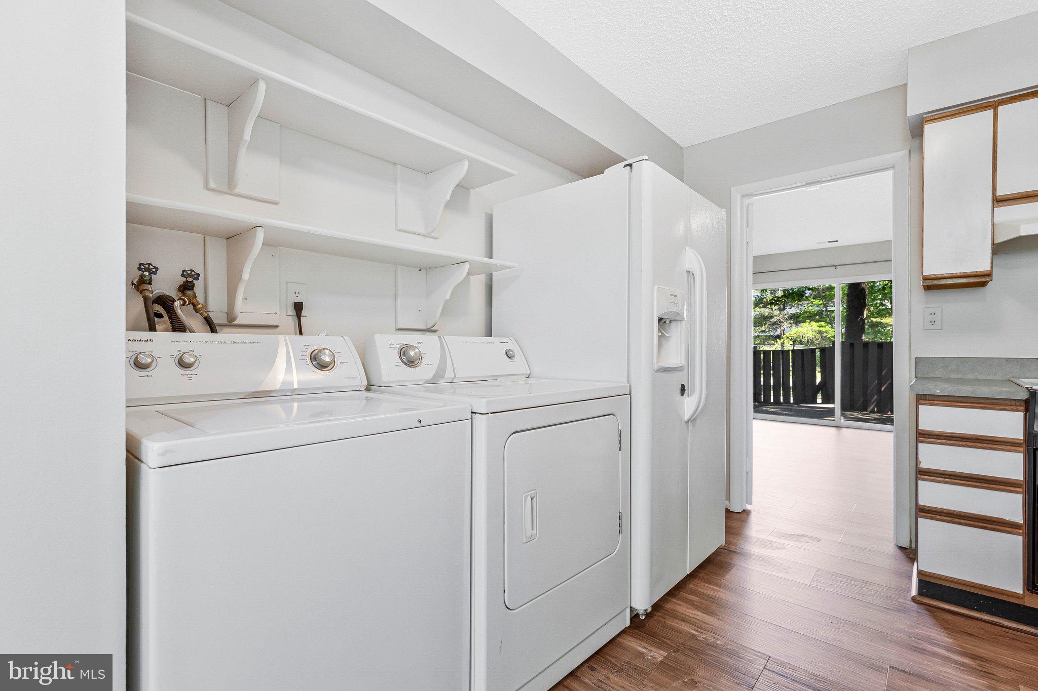 2202 Southgate Square Reston, VA 20191 - Photo 13 of 22 a utility room with cabinets washer and dryer