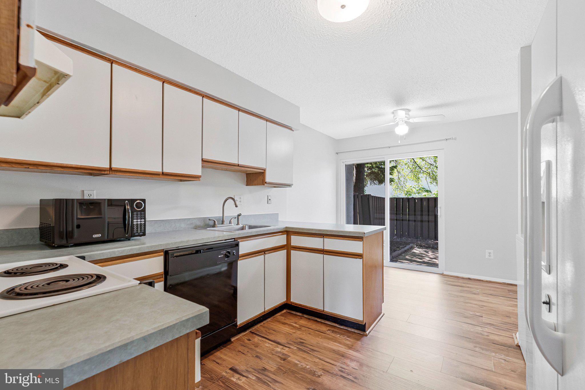 2202 Southgate Square Reston, VA 20191 - Photo 14 of 22 a kitchen with stainless steel appliances granite countertop a stove a sink and a microwave