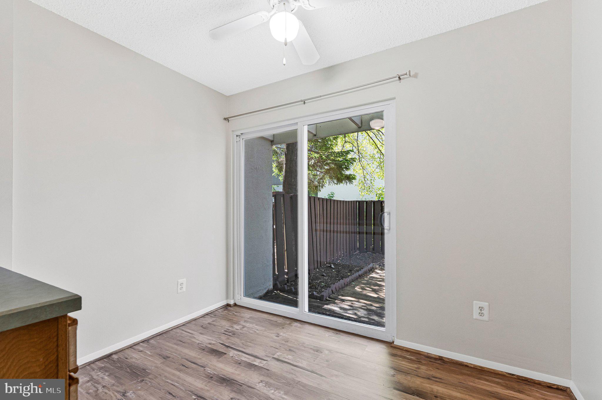 2202 Southgate Square Reston, VA 20191 - Photo 15 of 22 an empty room with wooden floor and windows