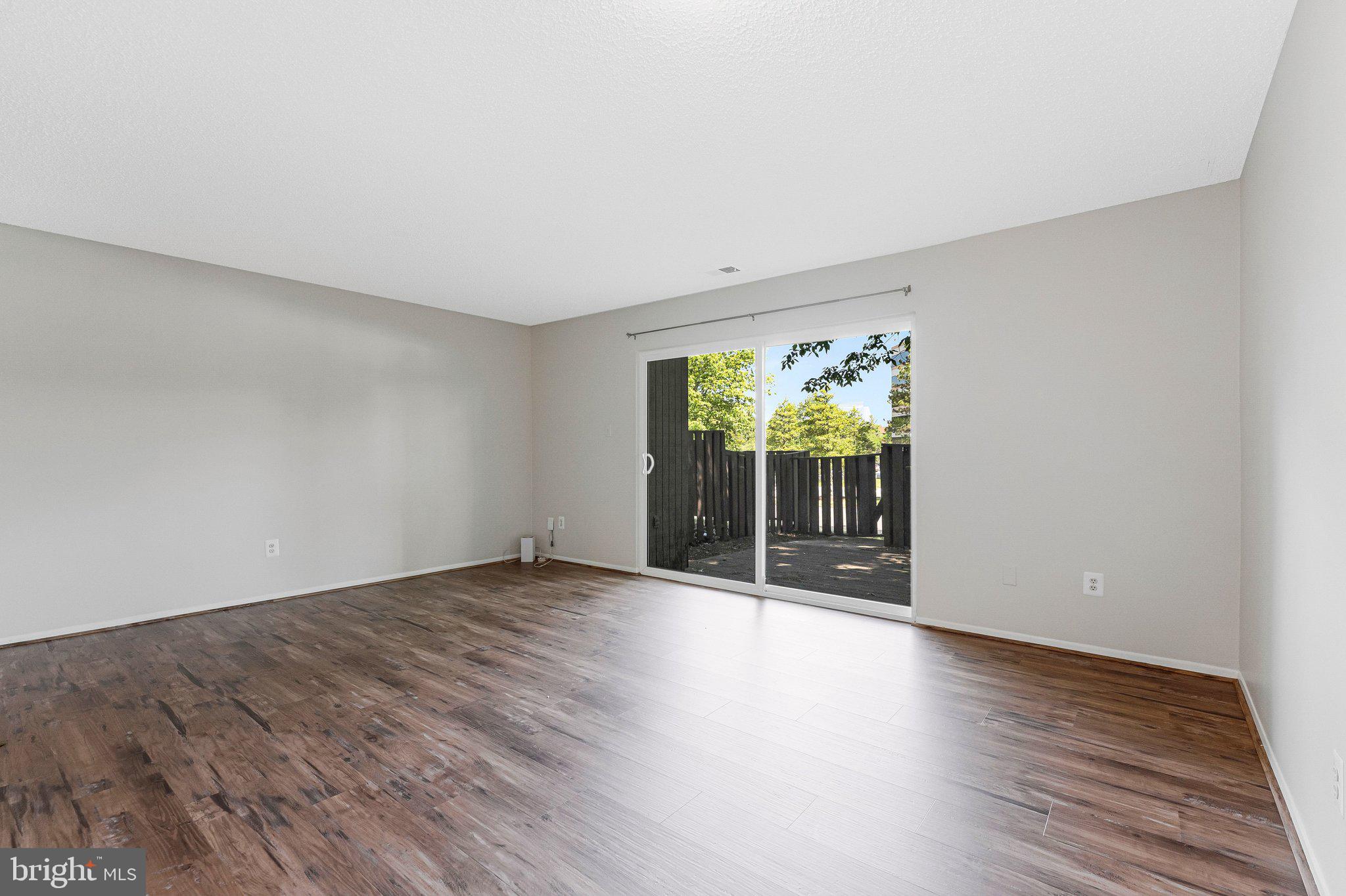 2202 Southgate Square Reston, VA 20191 - Photo 16 of 22 a view of an empty room with wooden floor and a window