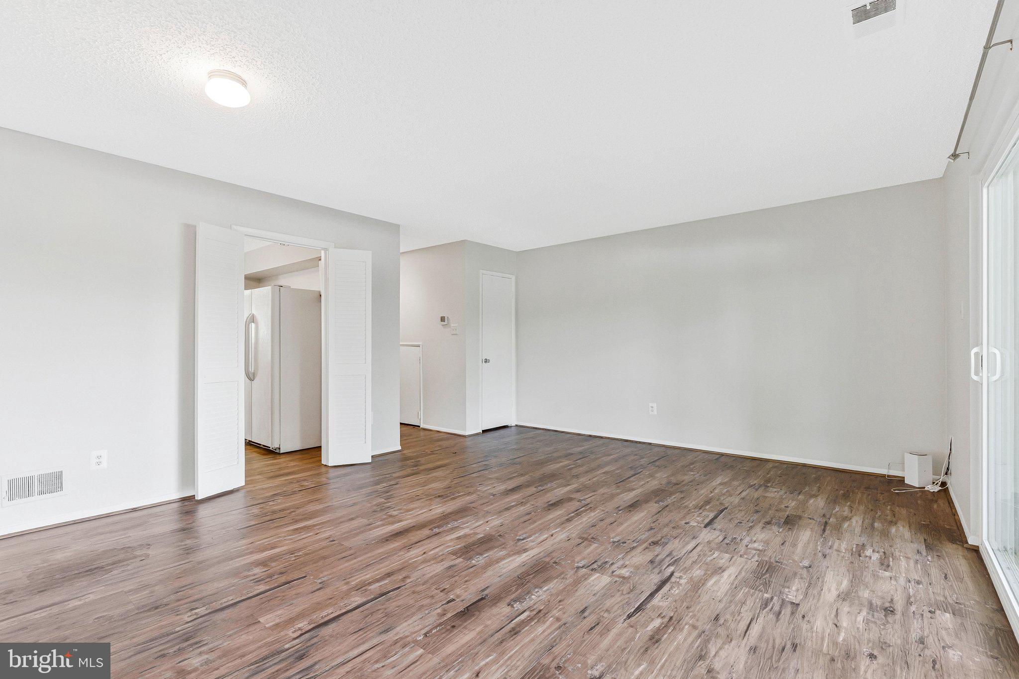 2202 Southgate Square Reston, VA 20191 - Photo 17 of 22 a view of an empty room with wooden floor and closet