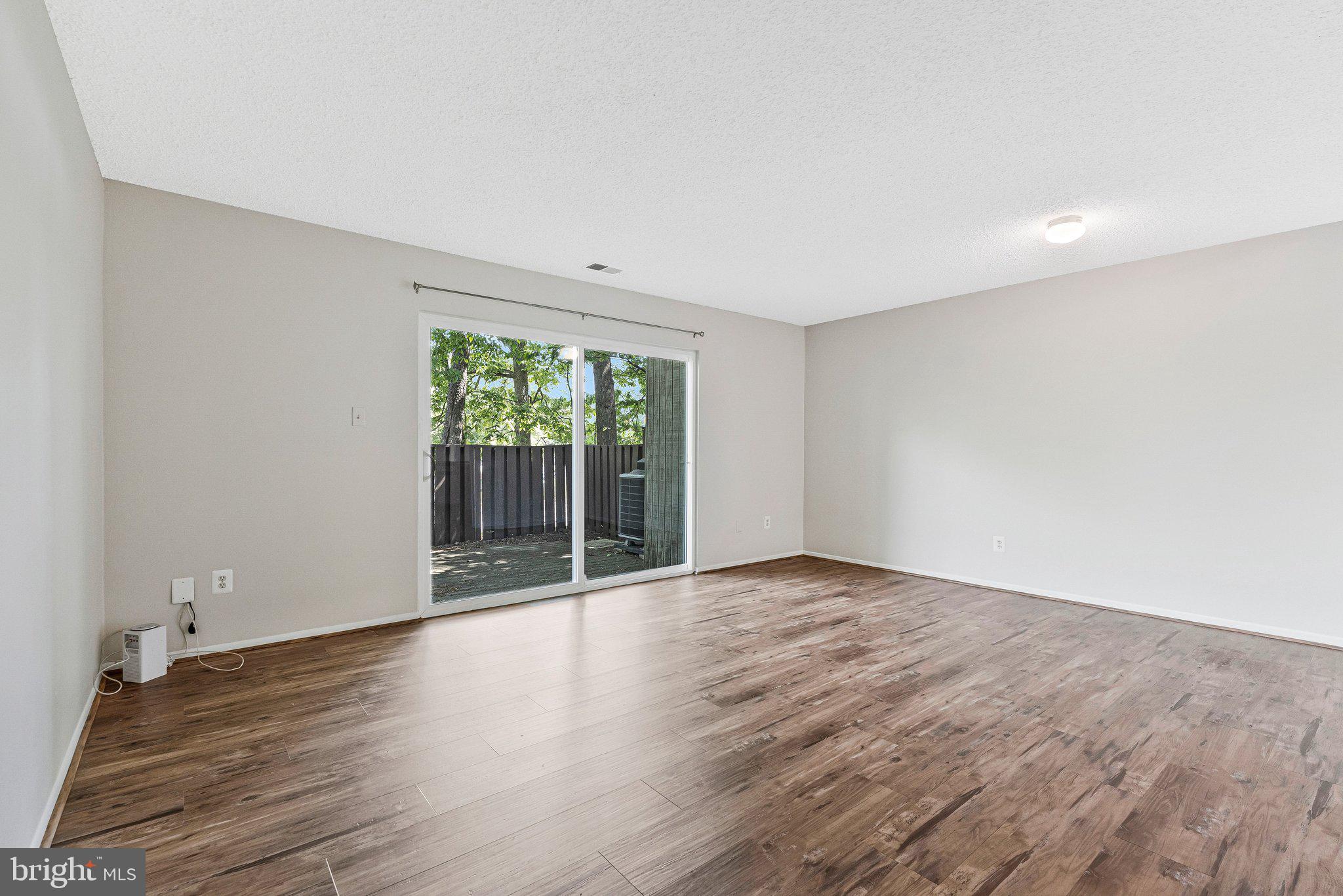2202 Southgate Square Reston, VA 20191 - Photo 18 of 22 a view of an empty room with wooden floor and a window