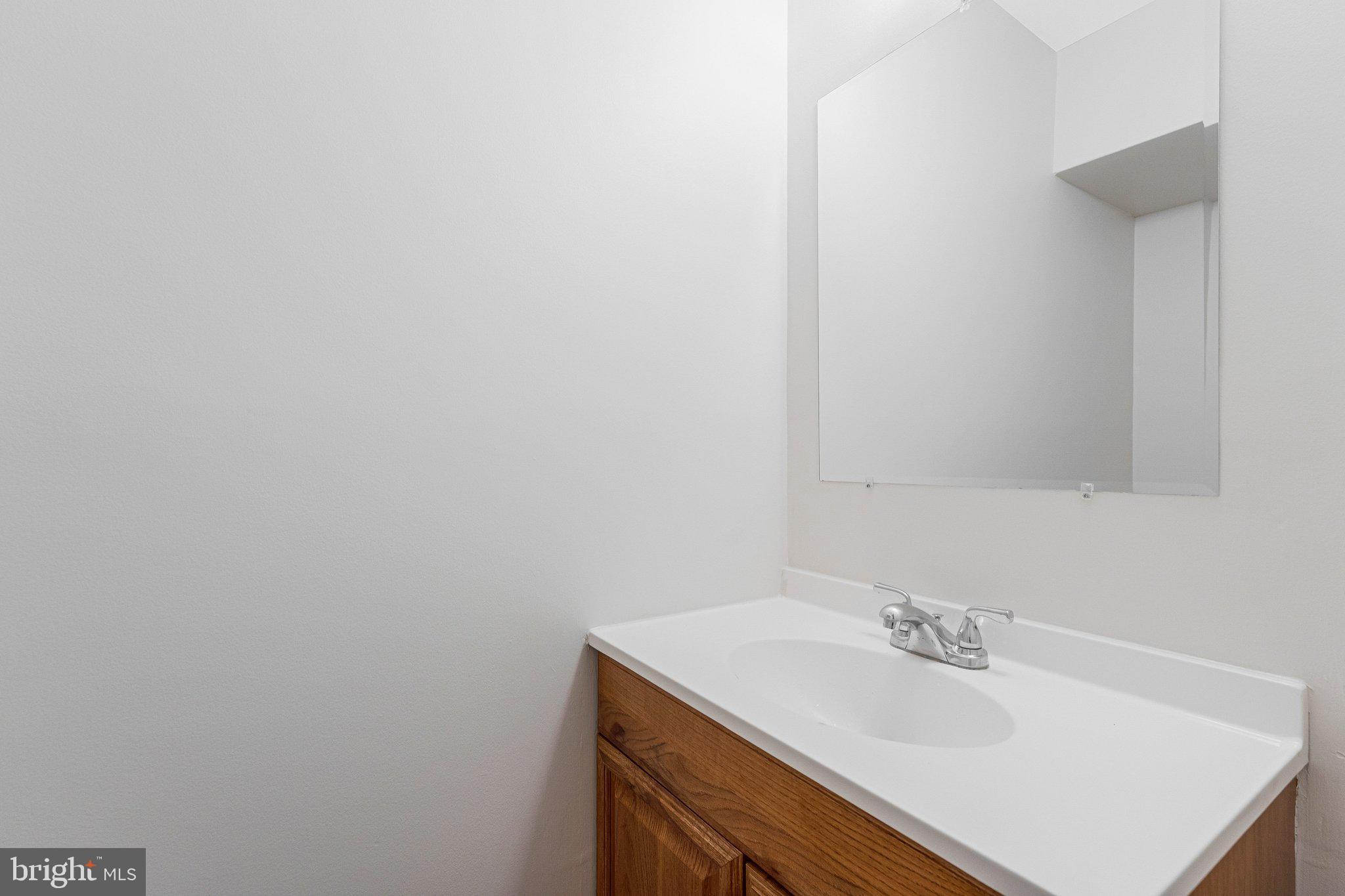 2202 Southgate Square Reston, VA 20191 - Photo 9 of 22 a bathroom with a sink vanity and a mirror