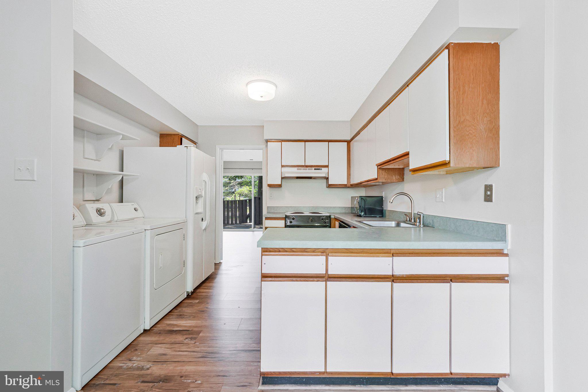 2202 Southgate Square Reston, VA 20191 - Photo 10 of 22 a kitchen with white cabinets and sink