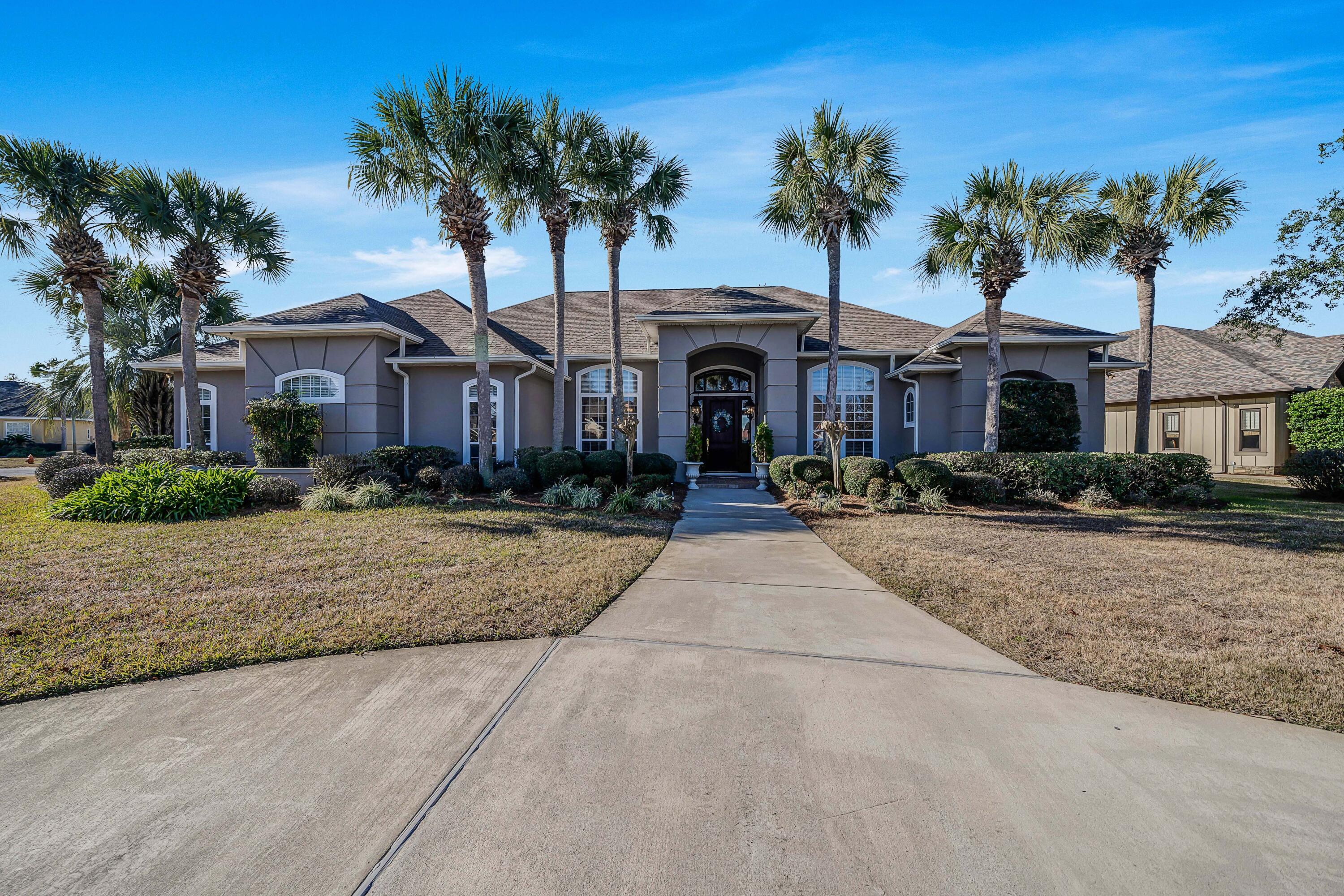 3601 Dragon's Ridge Road Panama City Beach, FL 32408 - Photo 1 of 62 a front view of a house with a yard and palm trees