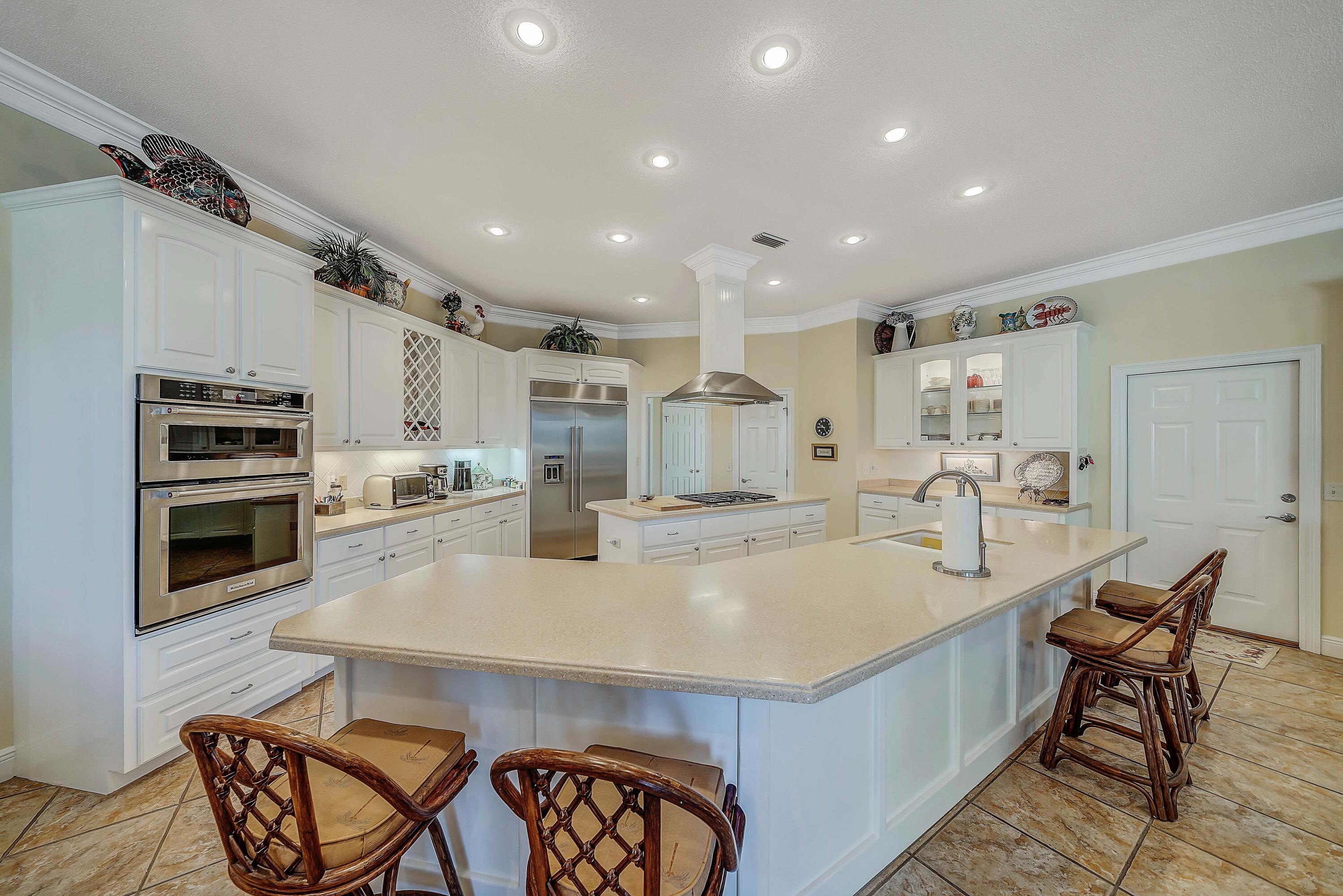 3601 Dragon's Ridge Road Panama City Beach, FL 32408 - Photo 12 of 62 a large kitchen with a table and chairs
