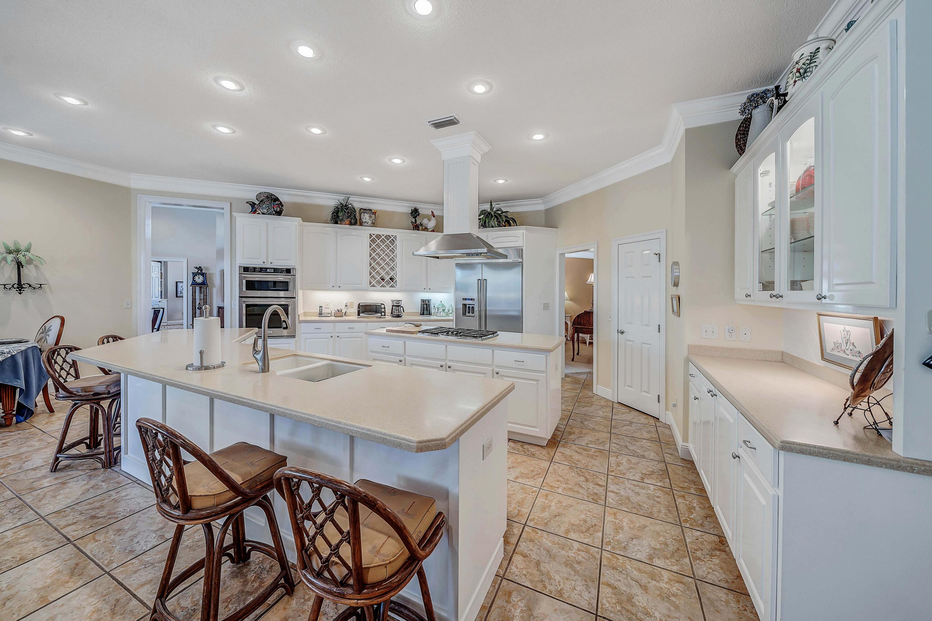 3601 Dragon's Ridge Road Panama City Beach, FL 32408 - Photo 13 of 62 a kitchen with stainless steel appliances kitchen island granite countertop a sink and cabinets
