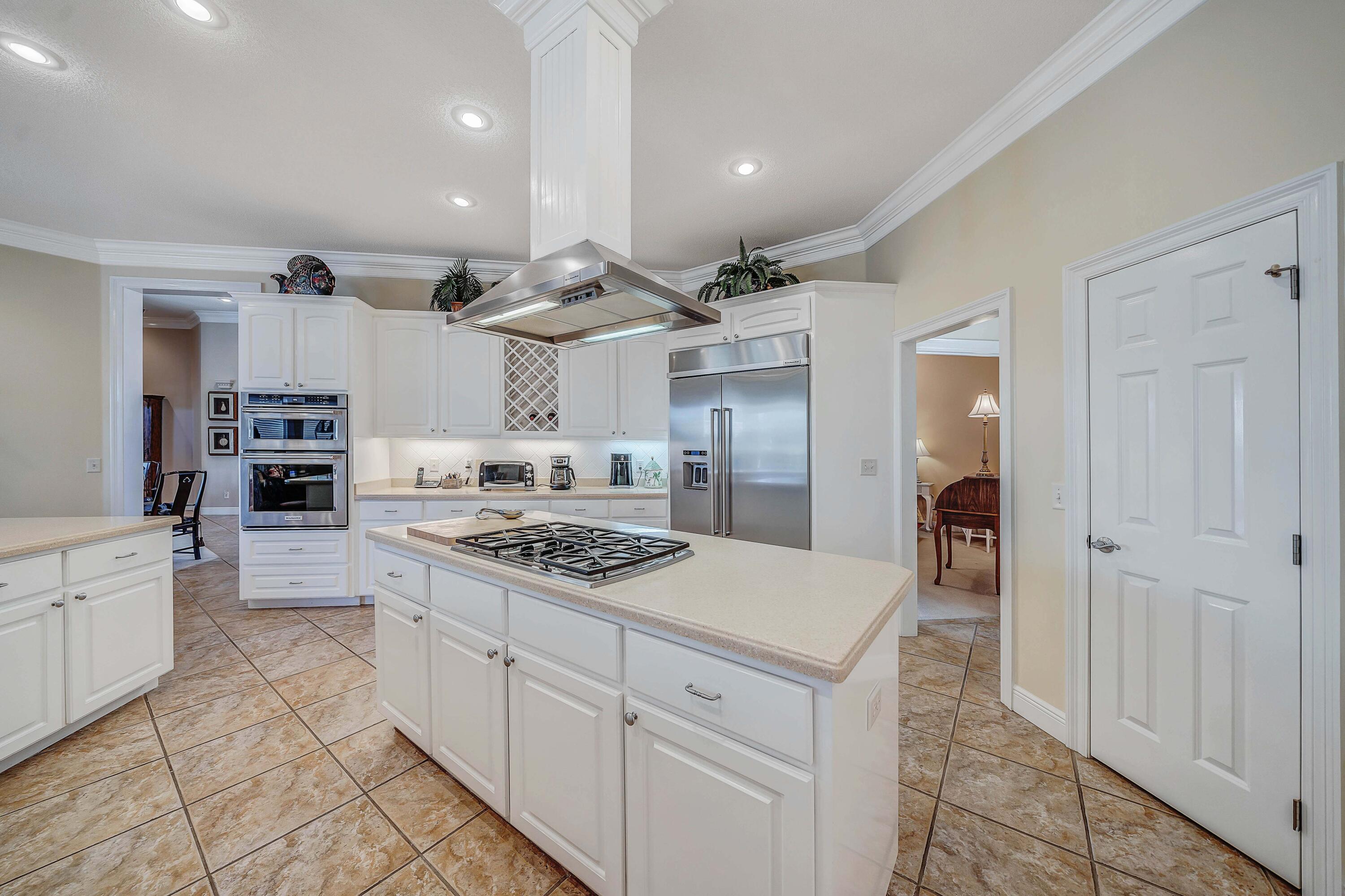 3601 Dragon's Ridge Road Panama City Beach, FL 32408 - Photo 14 of 62 a kitchen with a stove and cabinets