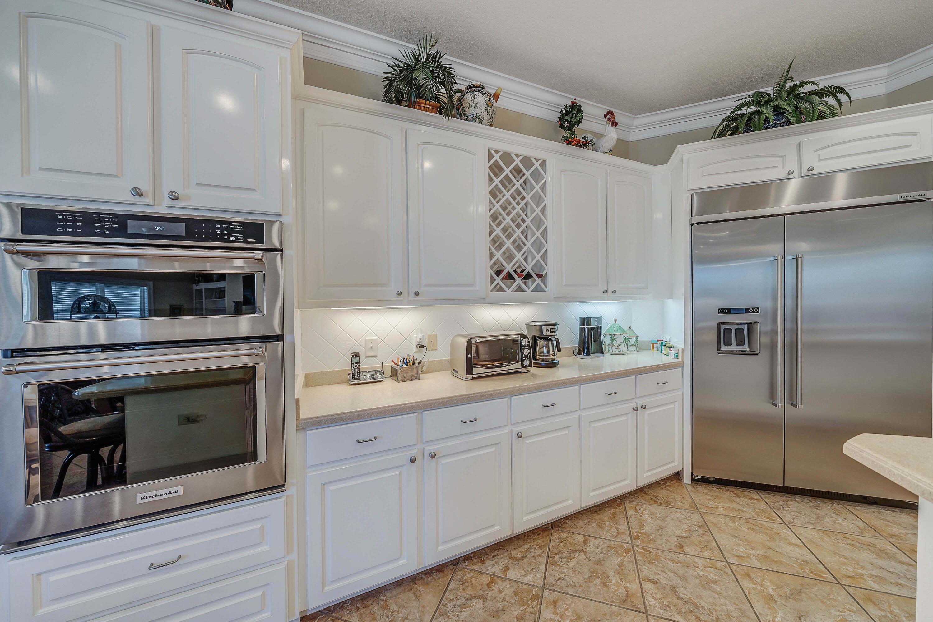 3601 Dragon's Ridge Road Panama City Beach, FL 32408 - Photo 16 of 62 a kitchen with stainless steel appliances a stove sink and refrigerator