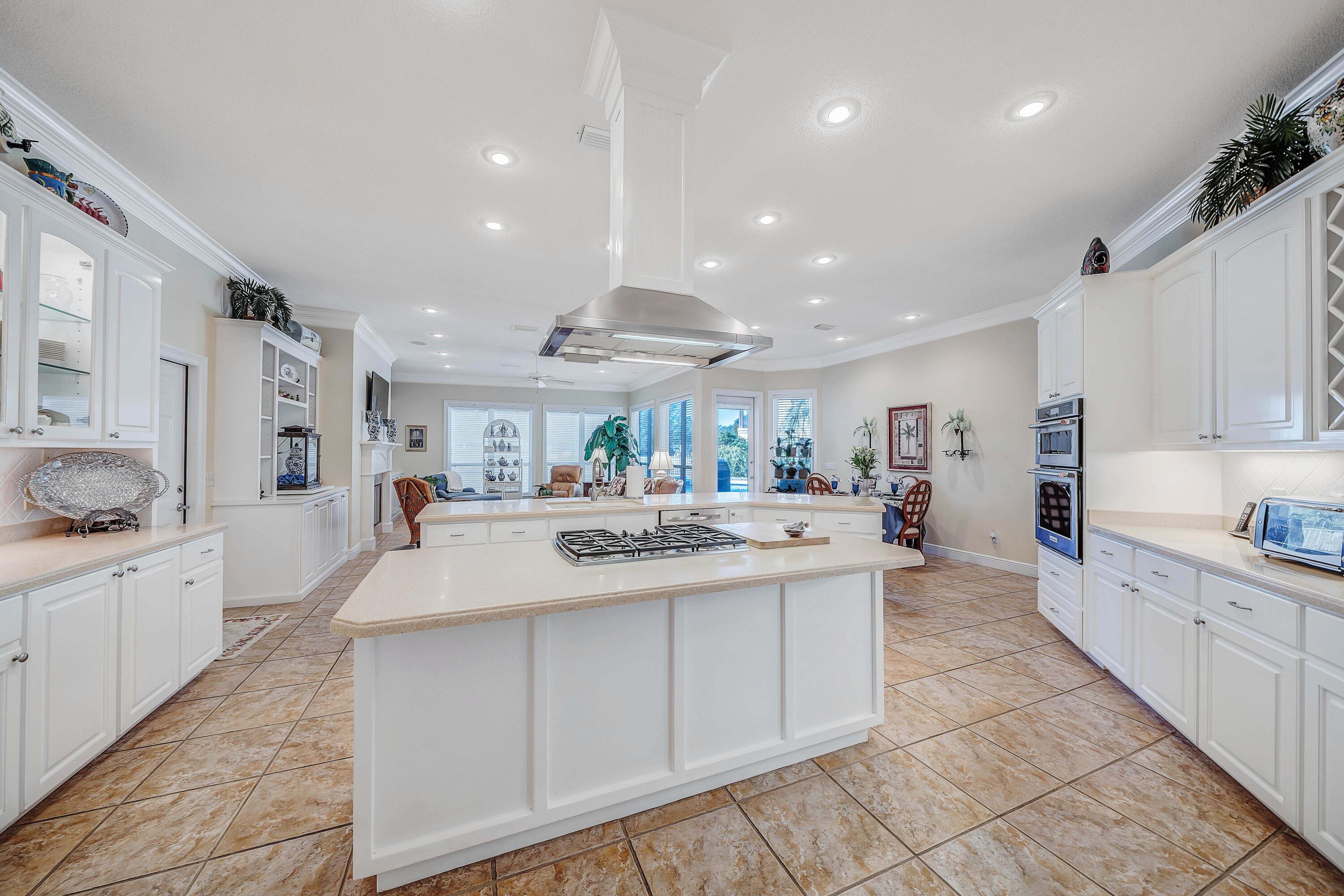 3601 Dragon's Ridge Road Panama City Beach, FL 32408 - Photo 18 of 62 a large kitchen with kitchen island a sink stainless steel appliances and cabinets