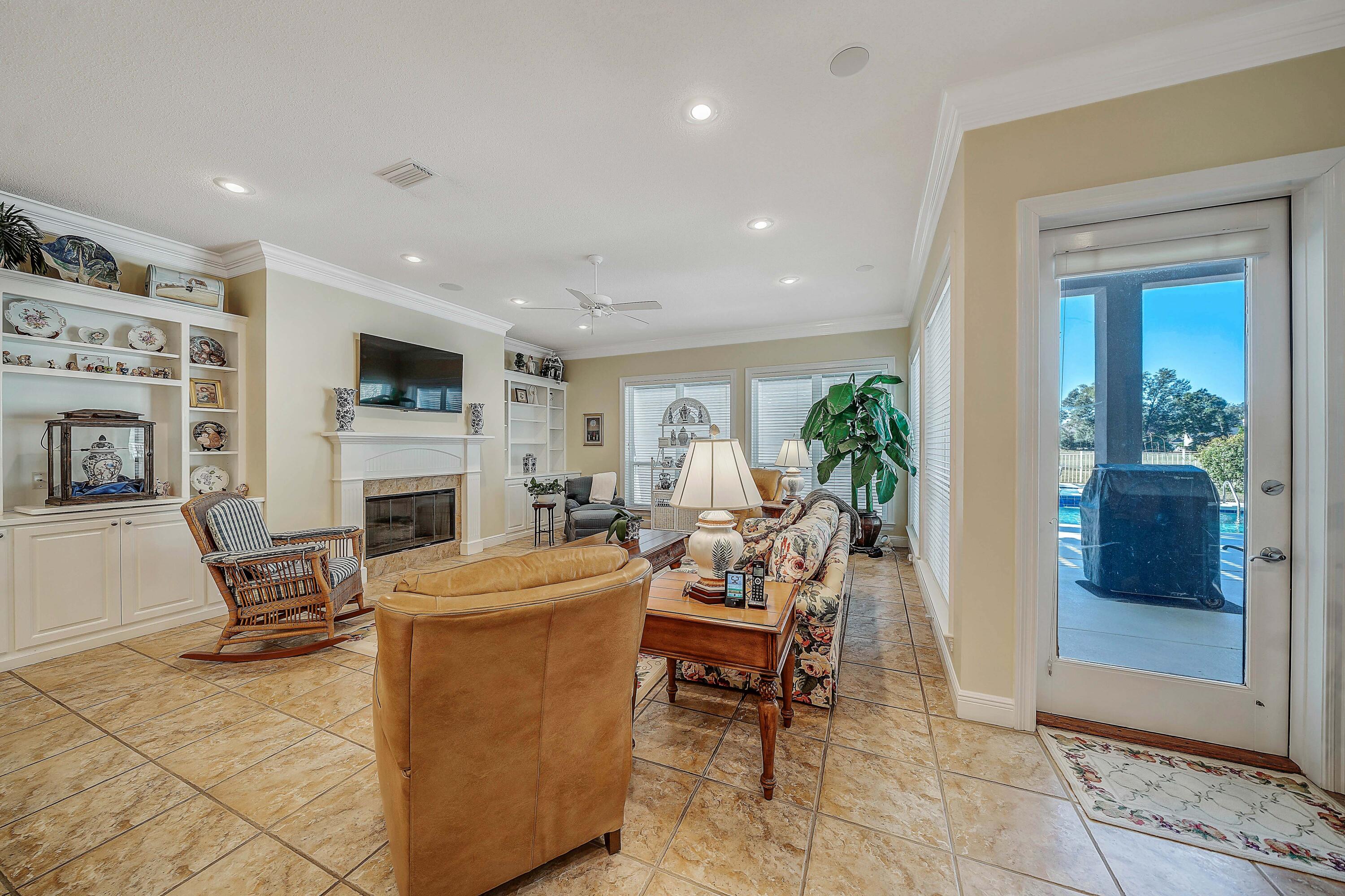 3601 Dragon's Ridge Road Panama City Beach, FL 32408 - Photo 20 of 62 a living room with furniture a fireplace and a flat screen tv