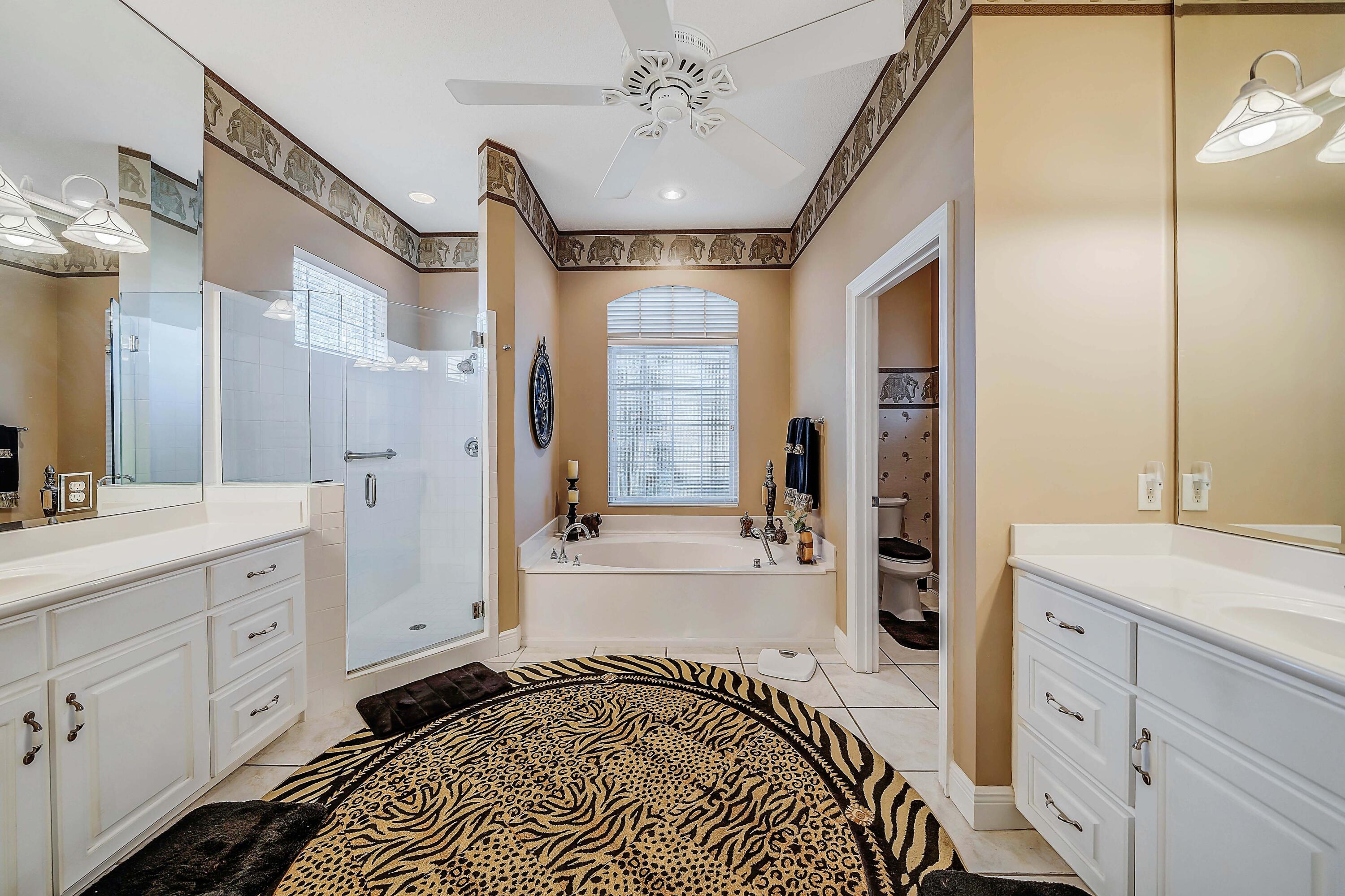 3601 Dragon's Ridge Road Panama City Beach, FL 32408 - Photo 28 of 62 a spacious bathroom with a double vanity sink a mirror and a bathtub