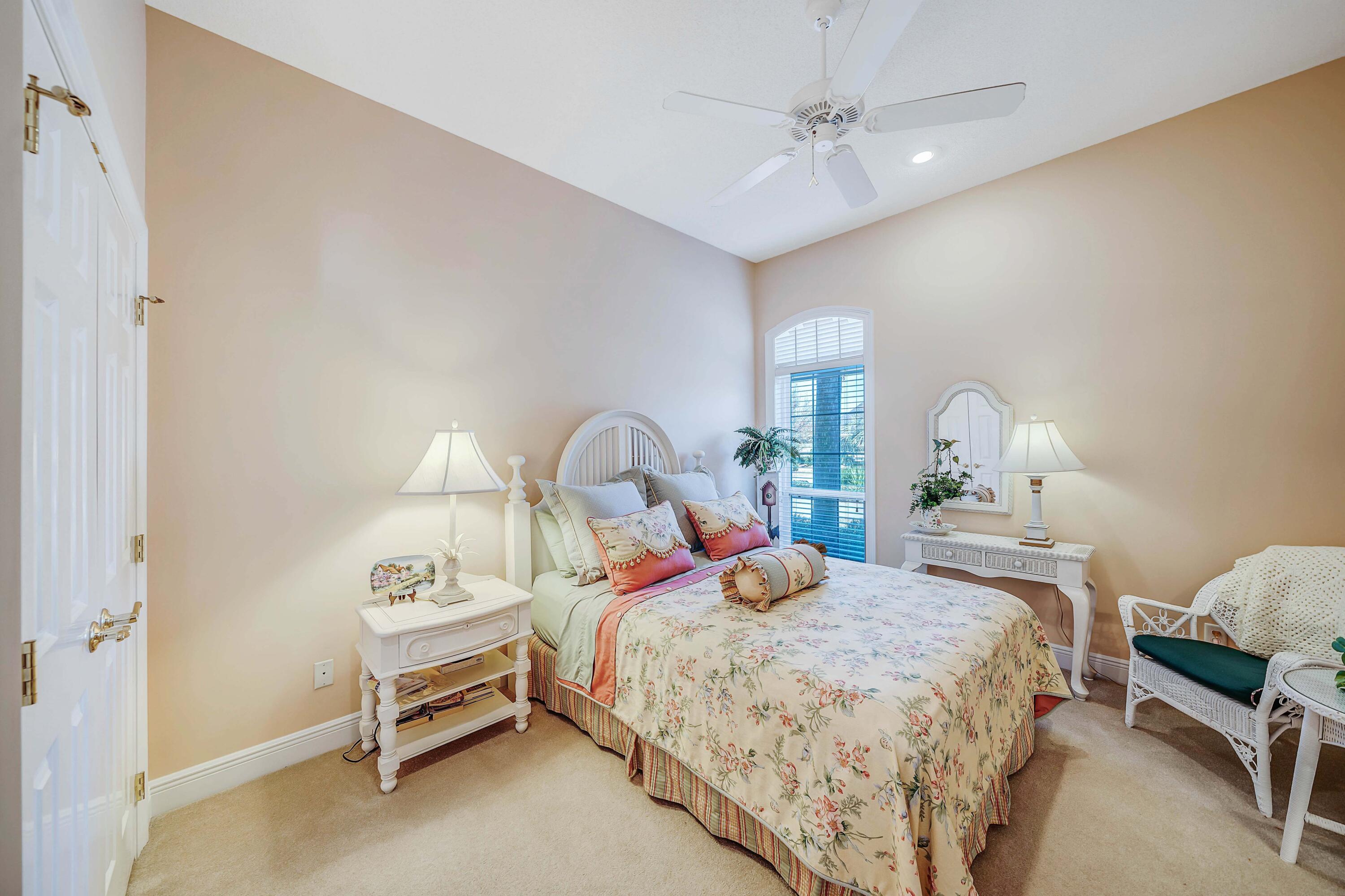 3601 Dragon's Ridge Road Panama City Beach, FL 32408 - Photo 29 of 62 a bedroom with a bed and a chandelier