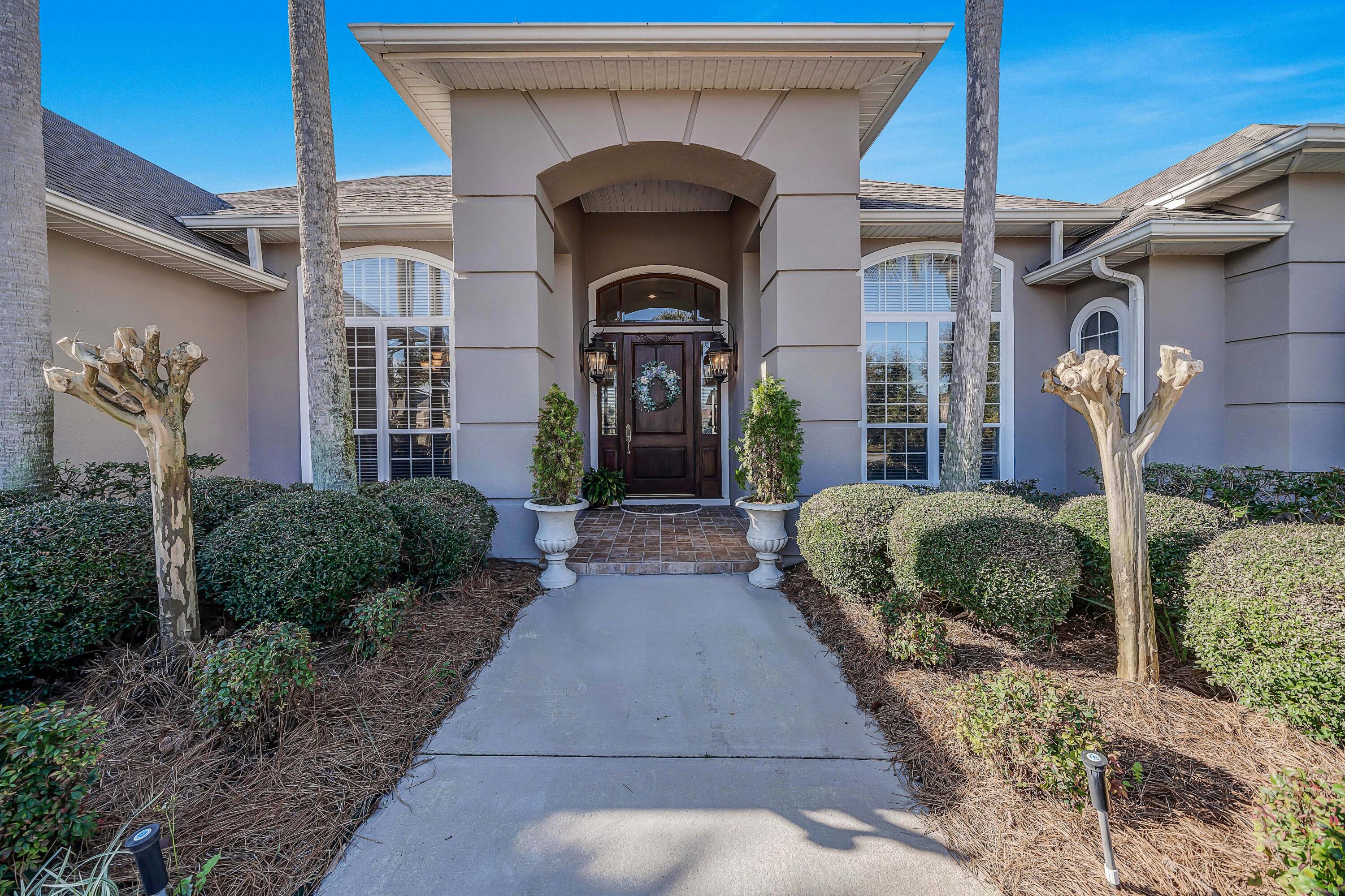 3601 Dragon's Ridge Road Panama City Beach, FL 32408 - Photo 3 of 62 a front view of a house with garden
