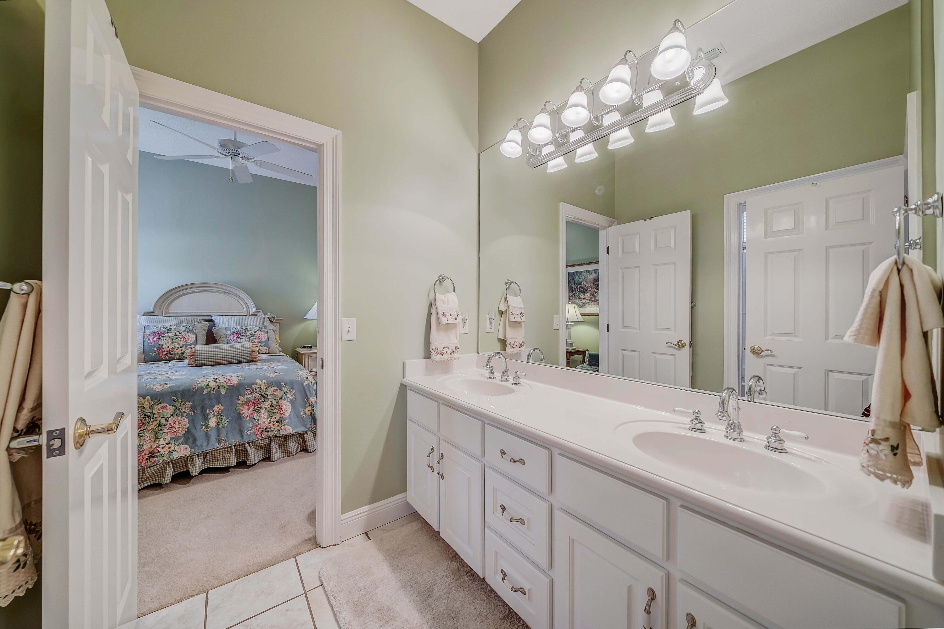 3601 Dragon's Ridge Road Panama City Beach, FL 32408 - Photo 31 of 62 a bathroom with a double vanity sink and a mirror