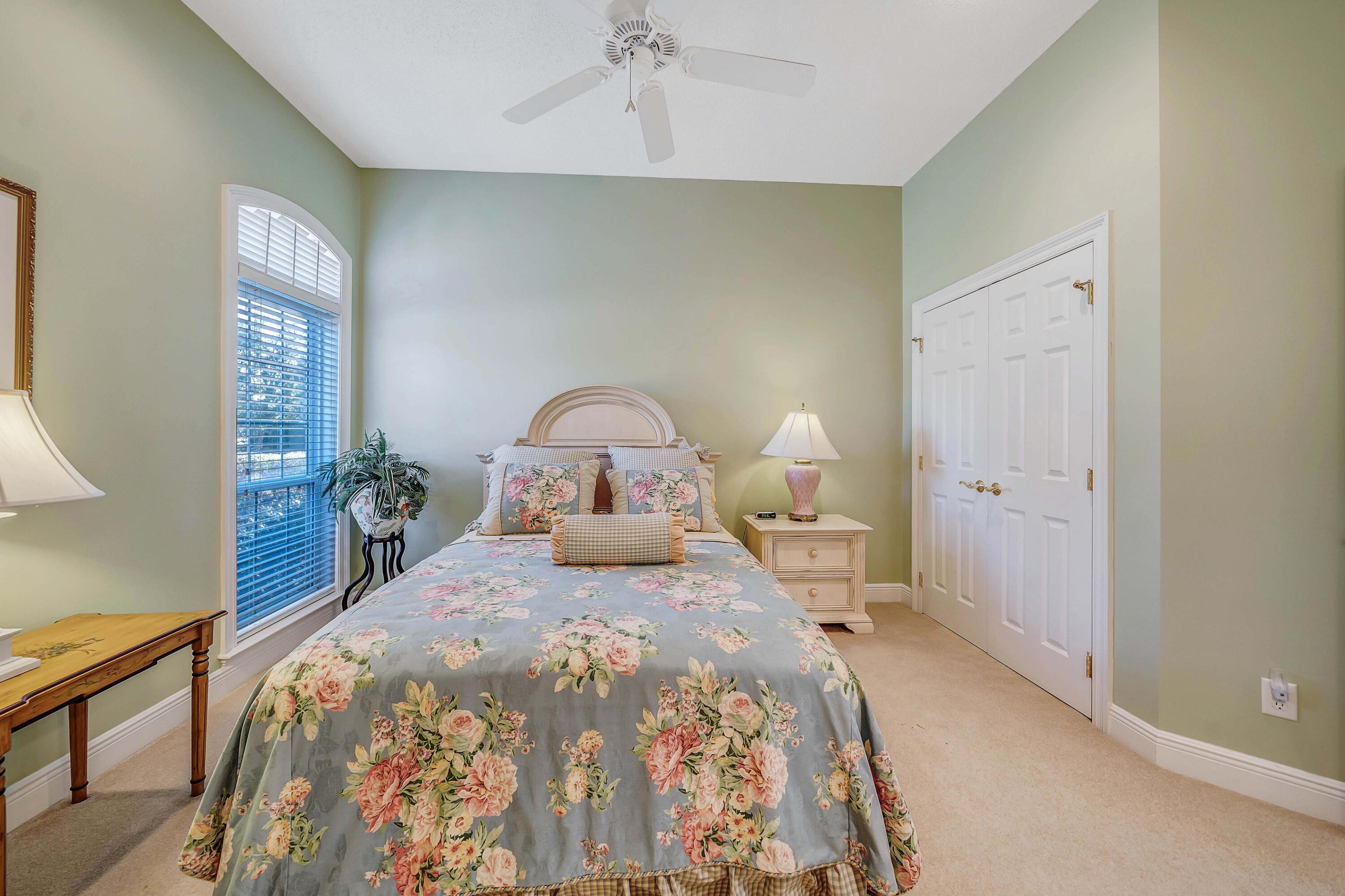 3601 Dragon's Ridge Road Panama City Beach, FL 32408 - Photo 34 of 62 a bedroom with a bed and a chandelier
