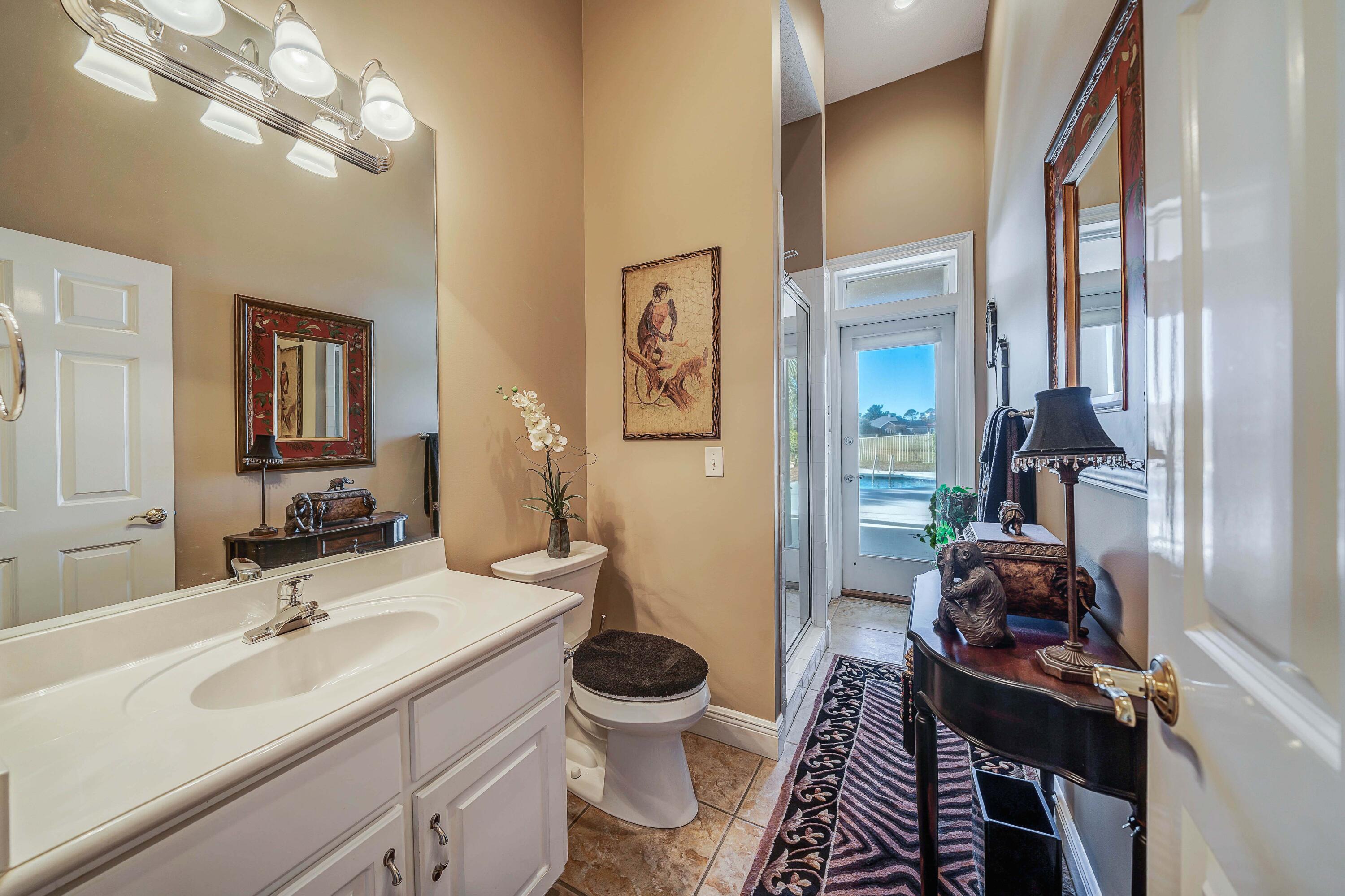 3601 Dragon's Ridge Road Panama City Beach, FL 32408 - Photo 36 of 62 a bathroom with a toilet sink and mirror
