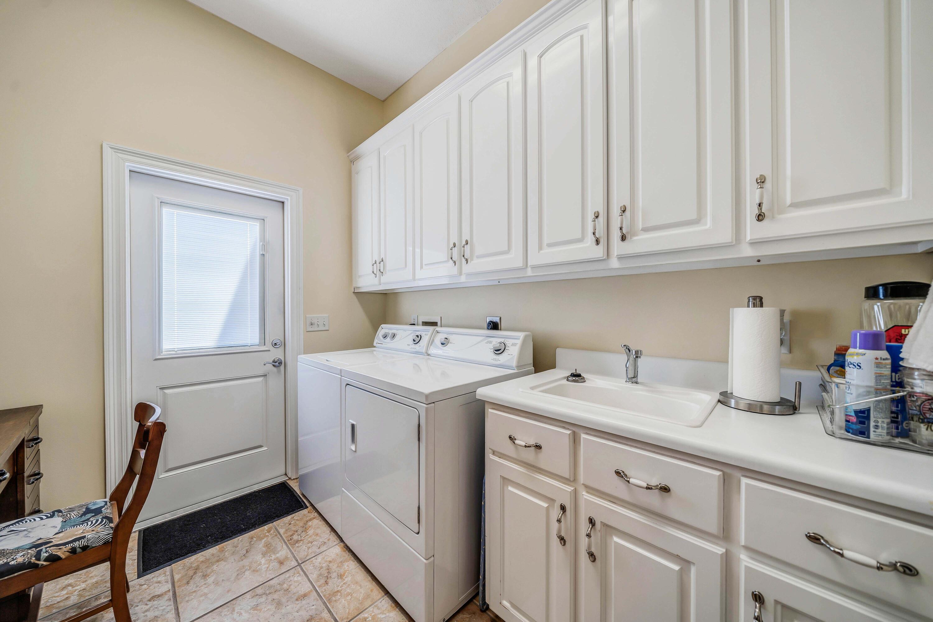3601 Dragon's Ridge Road Panama City Beach, FL 32408 - Photo 37 of 62 a utility room with cabinets washer and dryer