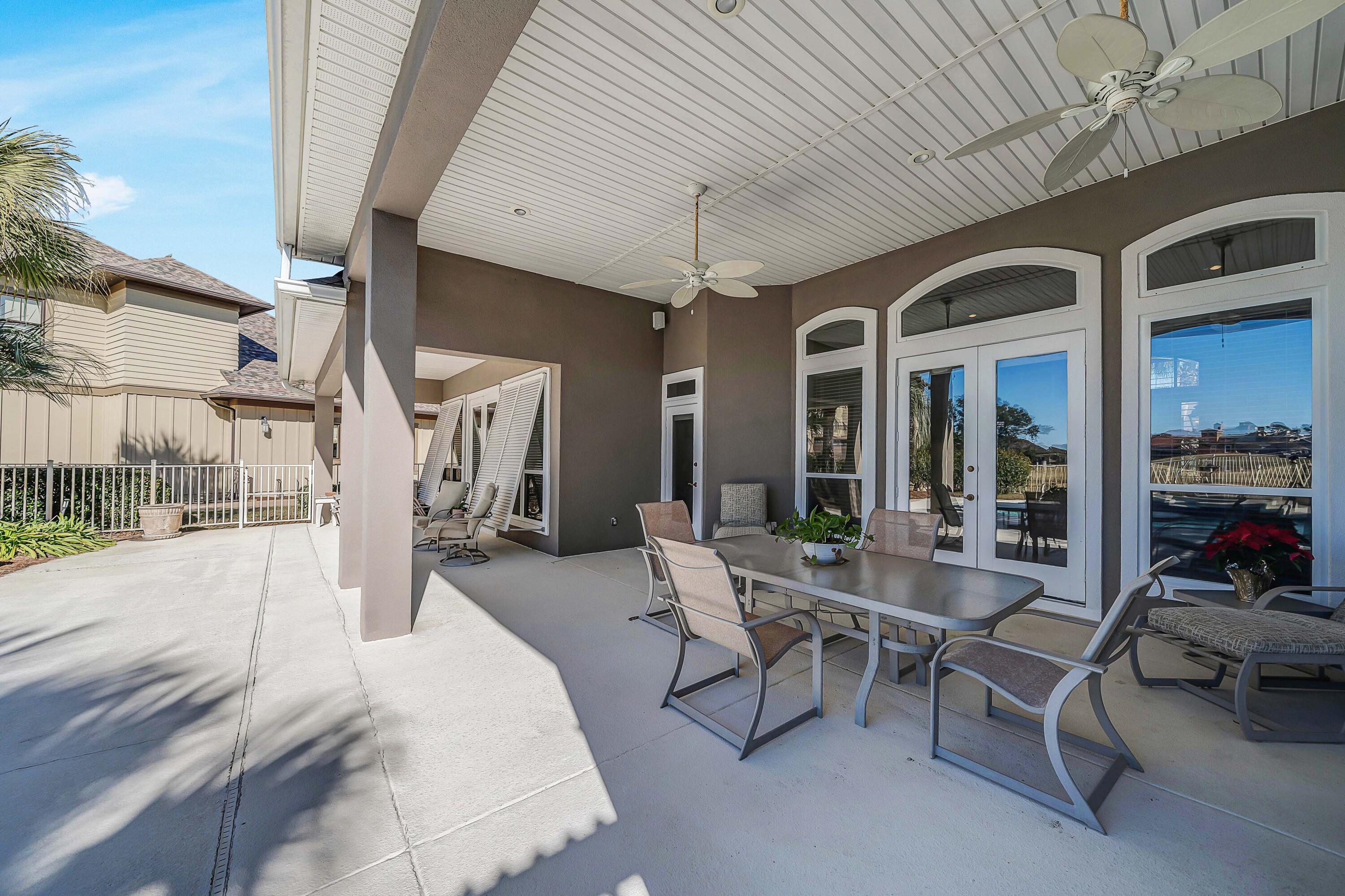3601 Dragon's Ridge Road Panama City Beach, FL 32408 - Photo 41 of 62 a building outdoor space with patio furniture and potted plants
