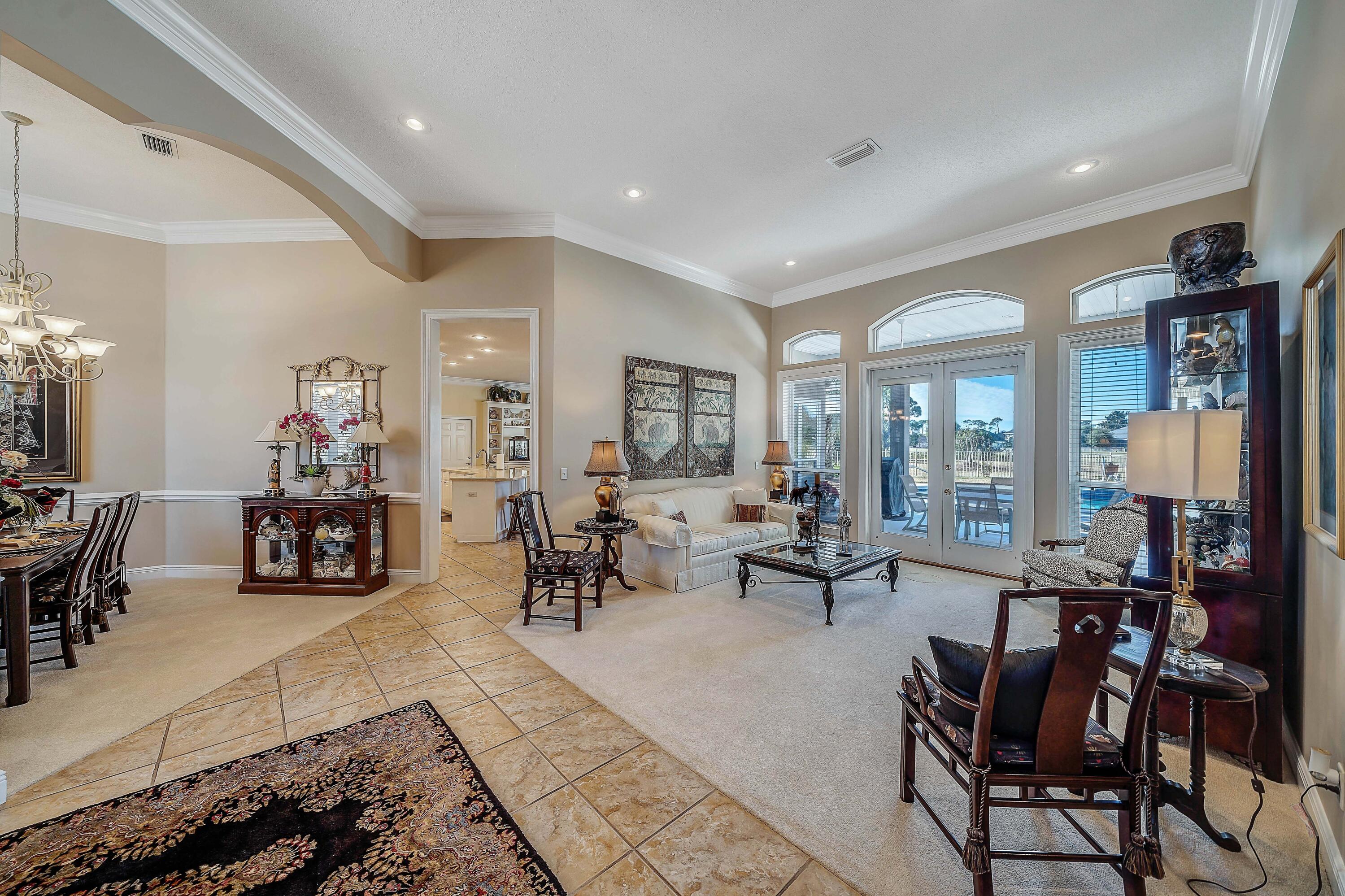 3601 Dragon's Ridge Road Panama City Beach, FL 32408 - Photo 6 of 62 a living room with furniture and a large window with outdoor views