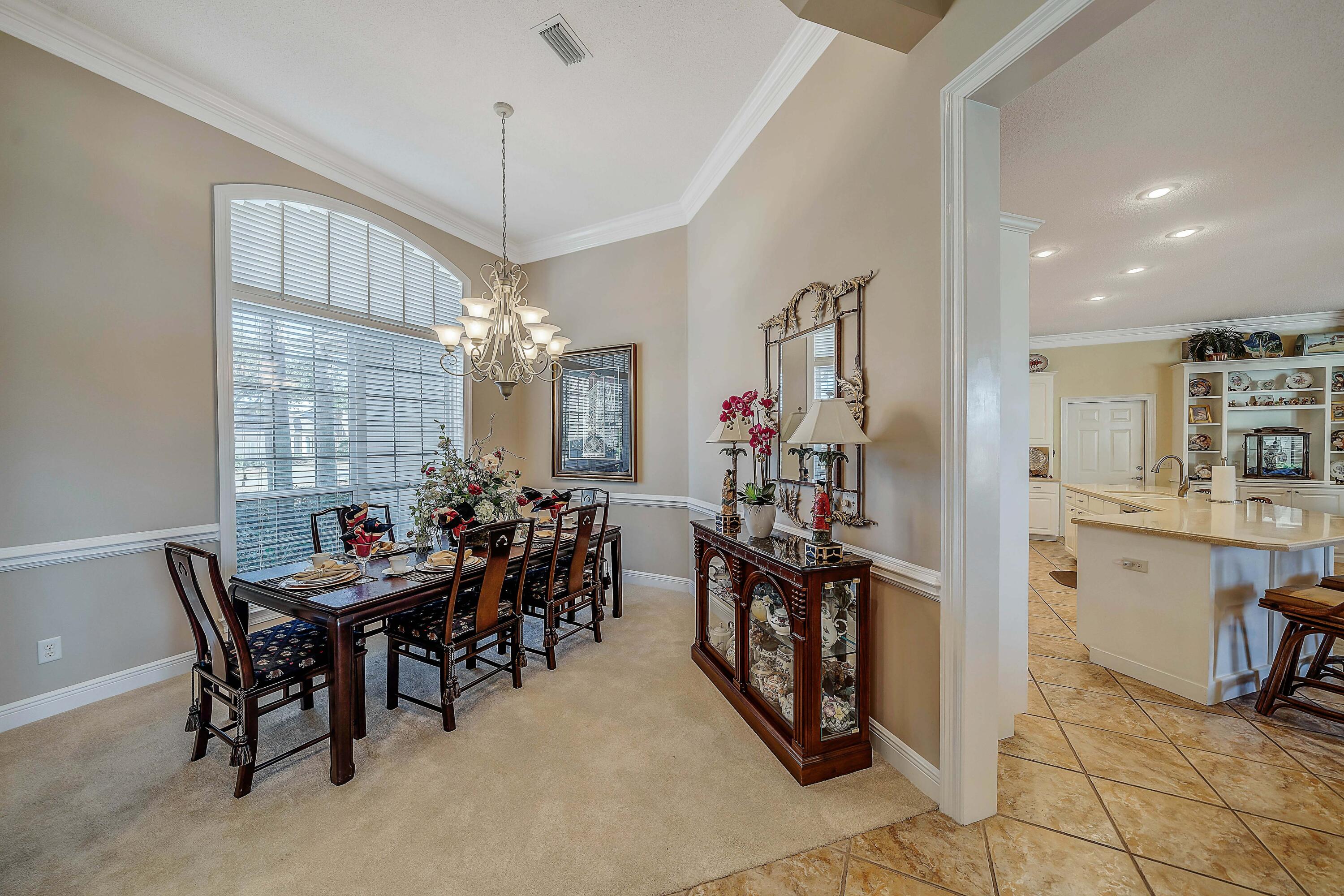3601 Dragon's Ridge Road Panama City Beach, FL 32408 - Photo 8 of 62 a view of a dining room with furniture and a chandelier