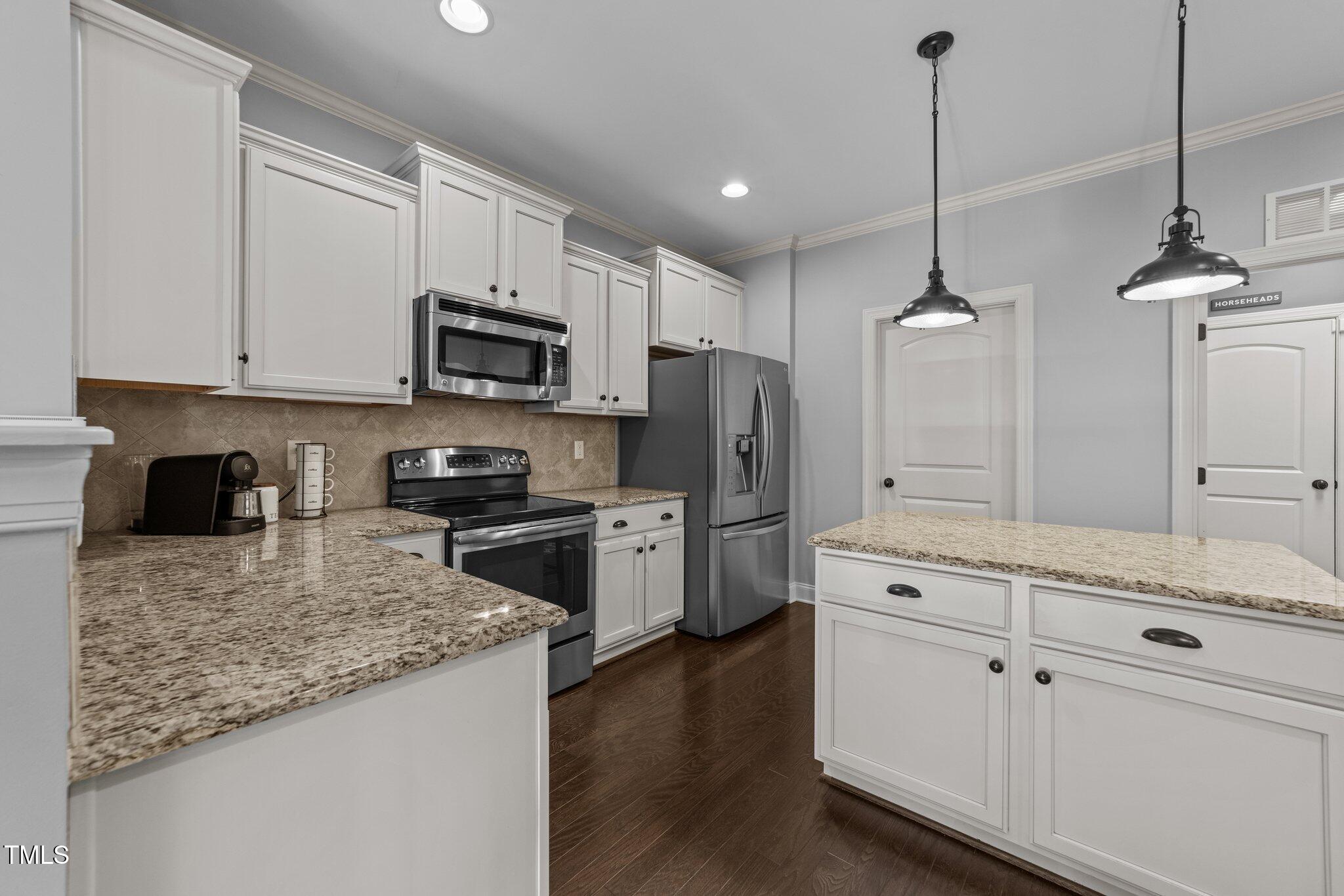 7520 Channery Way Raleigh, NC 27616 - Photo 17 of 47 a kitchen with stainless steel appliances granite countertop a refrigerator a stove a sink and white cabinets