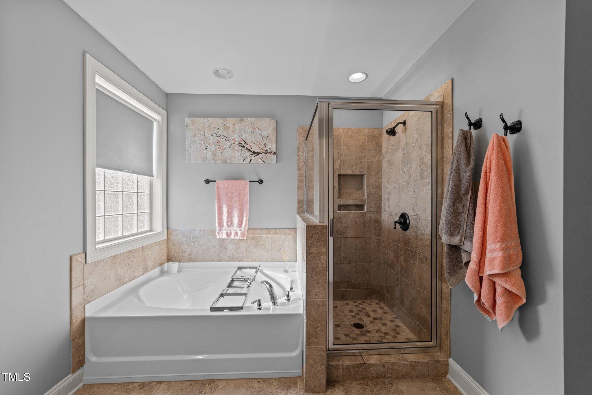 7520 Channery Way Raleigh, NC 27616 - Photo 25 of 47 a bathroom with a bathtub and a shower