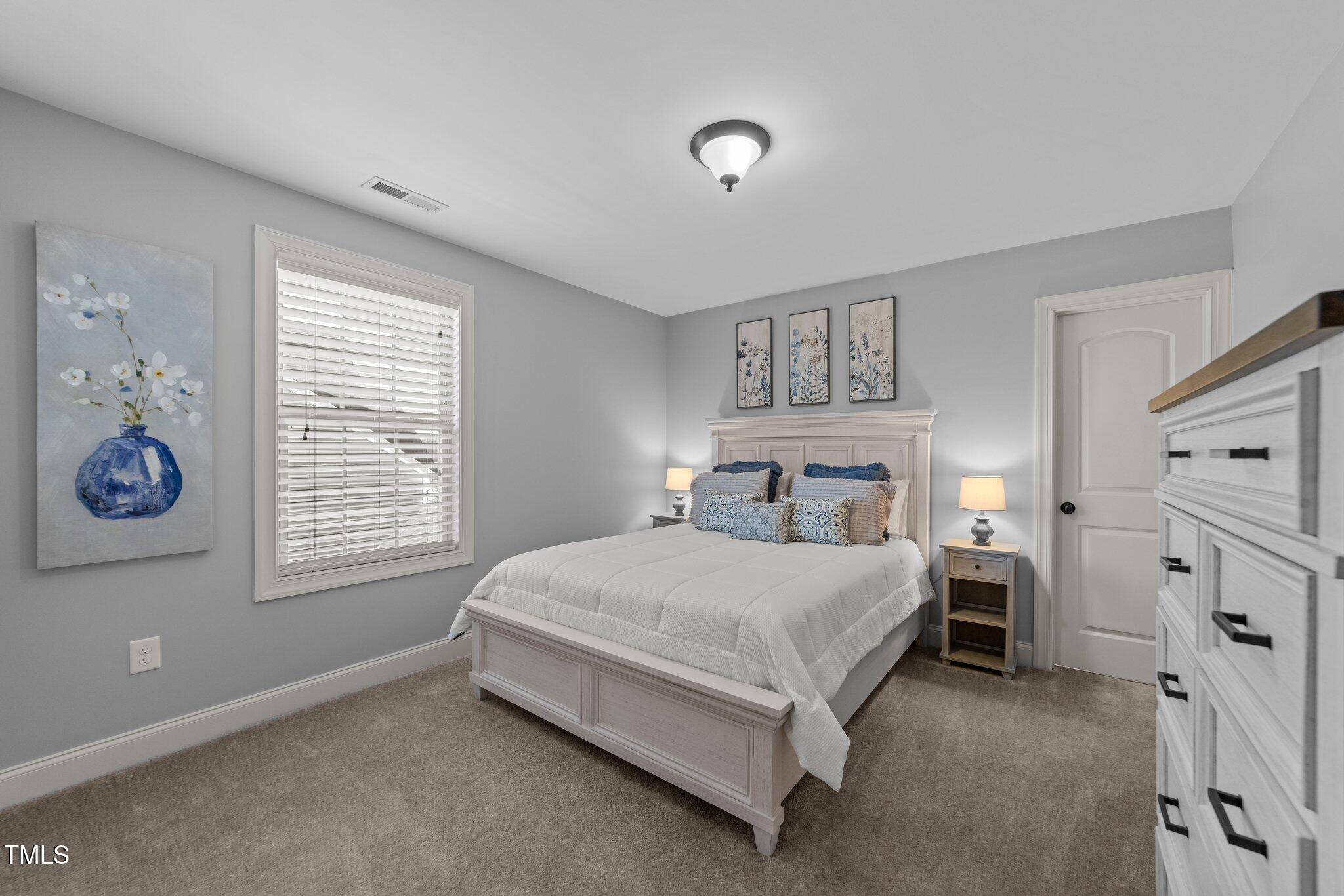 7520 Channery Way Raleigh, NC 27616 - Photo 26 of 47 a bedroom with a bed and a window