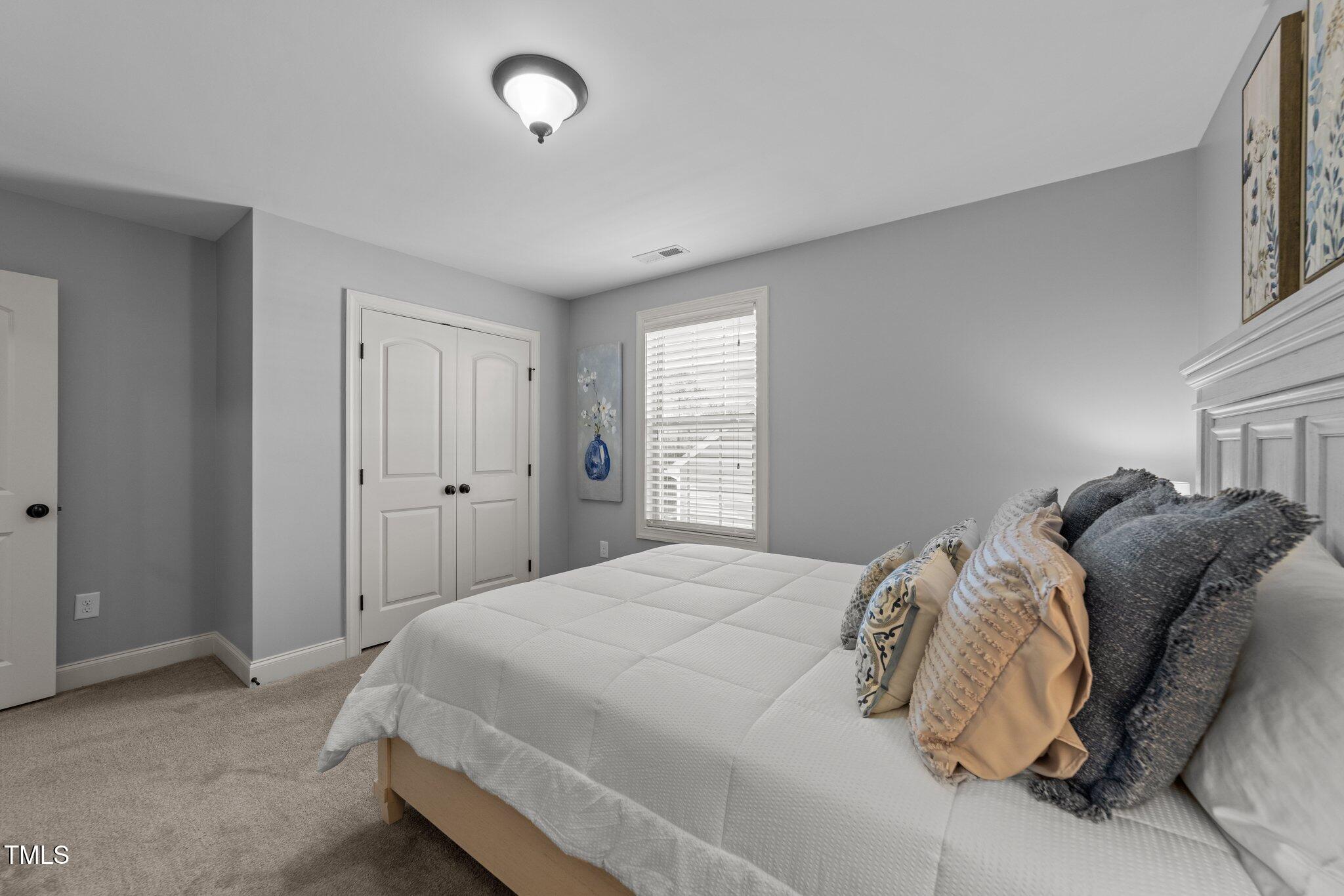 7520 Channery Way Raleigh, NC 27616 - Photo 27 of 47 a bedroom with a bed and a window