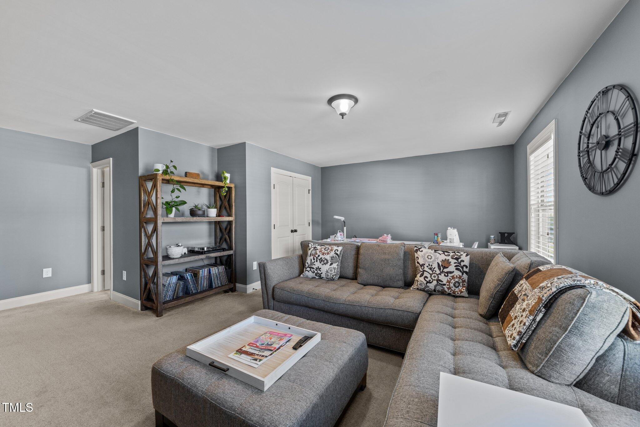 7520 Channery Way Raleigh, NC 27616 - Photo 29 of 47 a living room with furniture and a bookshelf