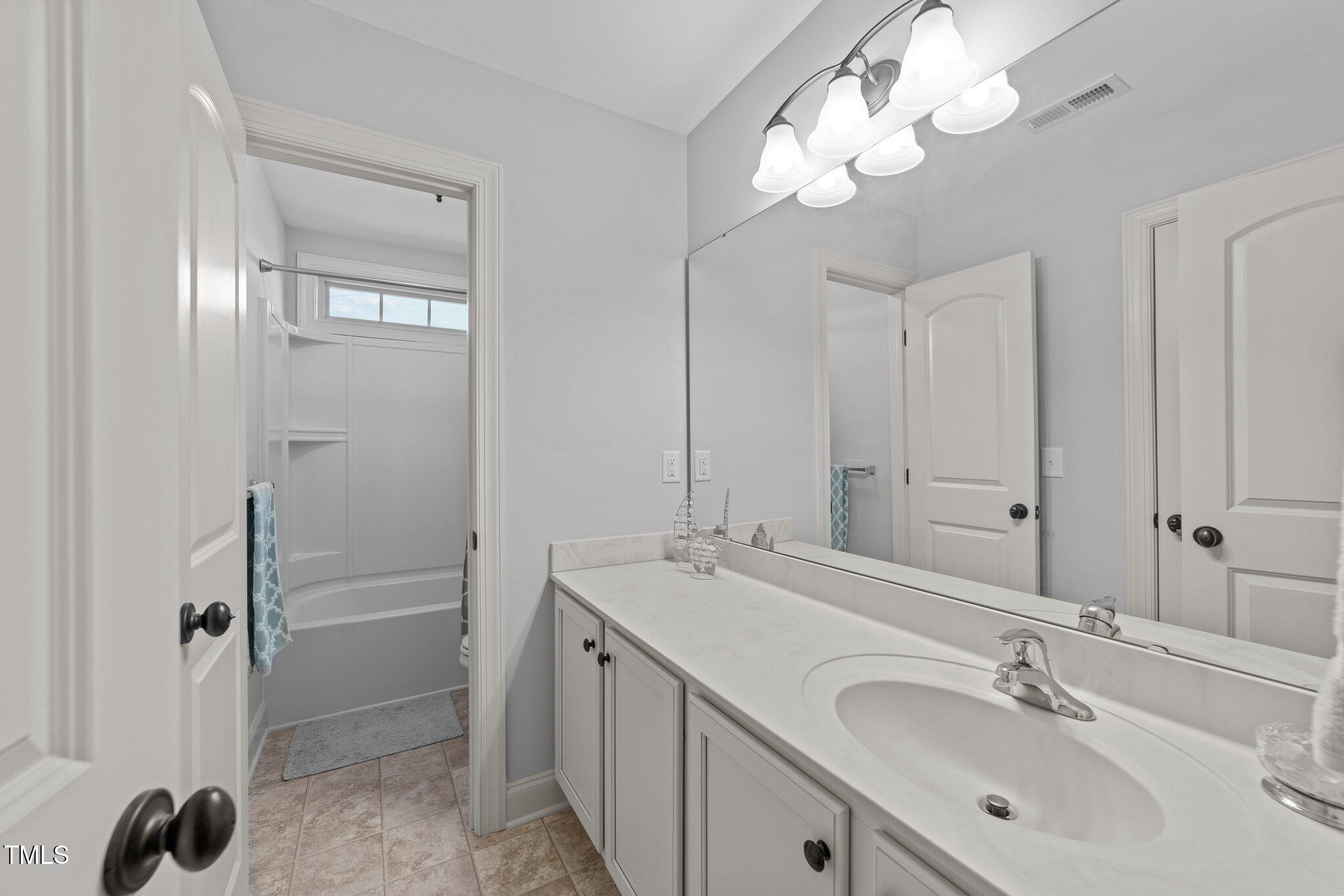 7520 Channery Way Raleigh, NC 27616 - Photo 30 of 47 a bathroom with a sink a light fixture and a mirror