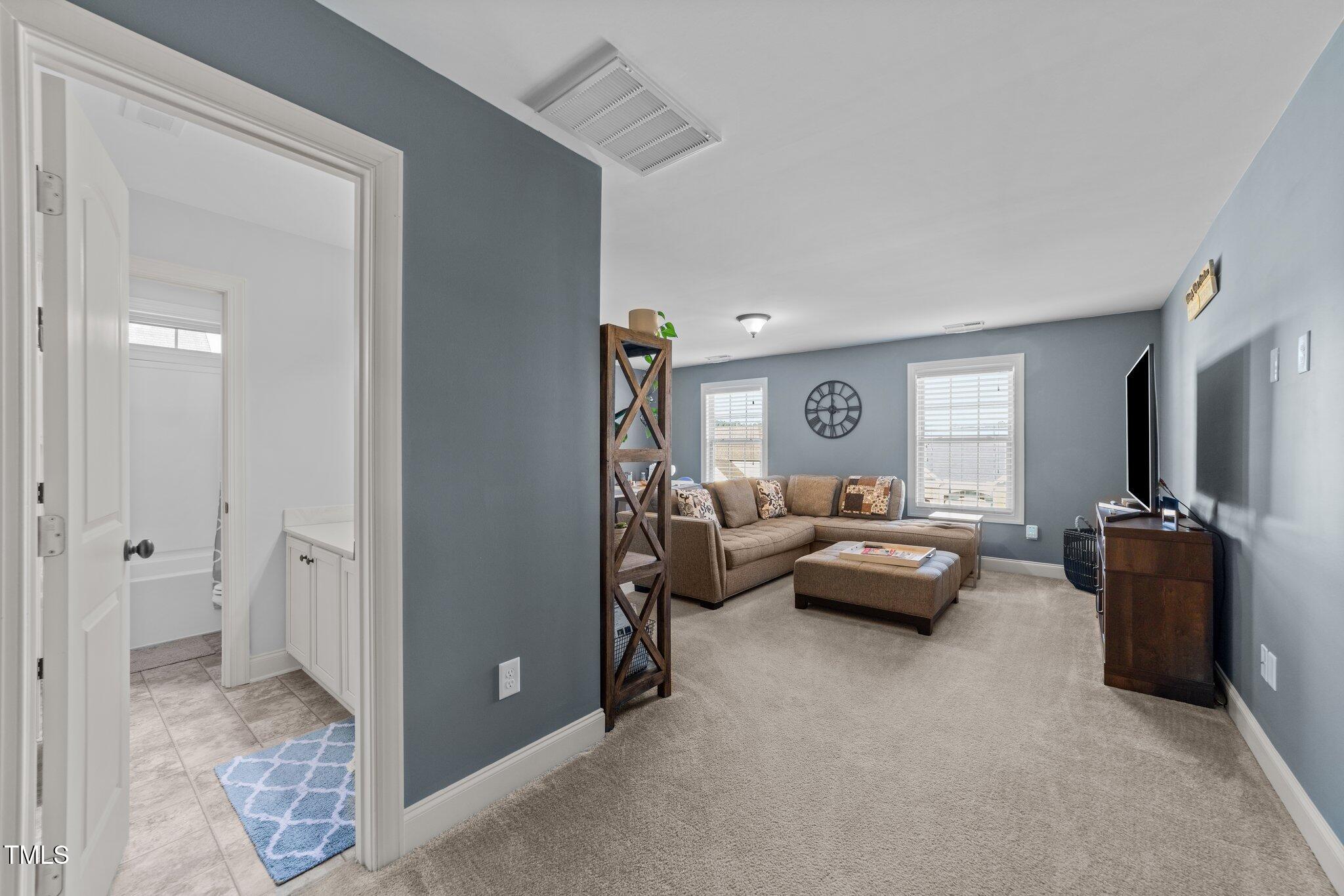 7520 Channery Way Raleigh, NC 27616 - Photo 32 of 47 a living room with furniture and a flat screen tv