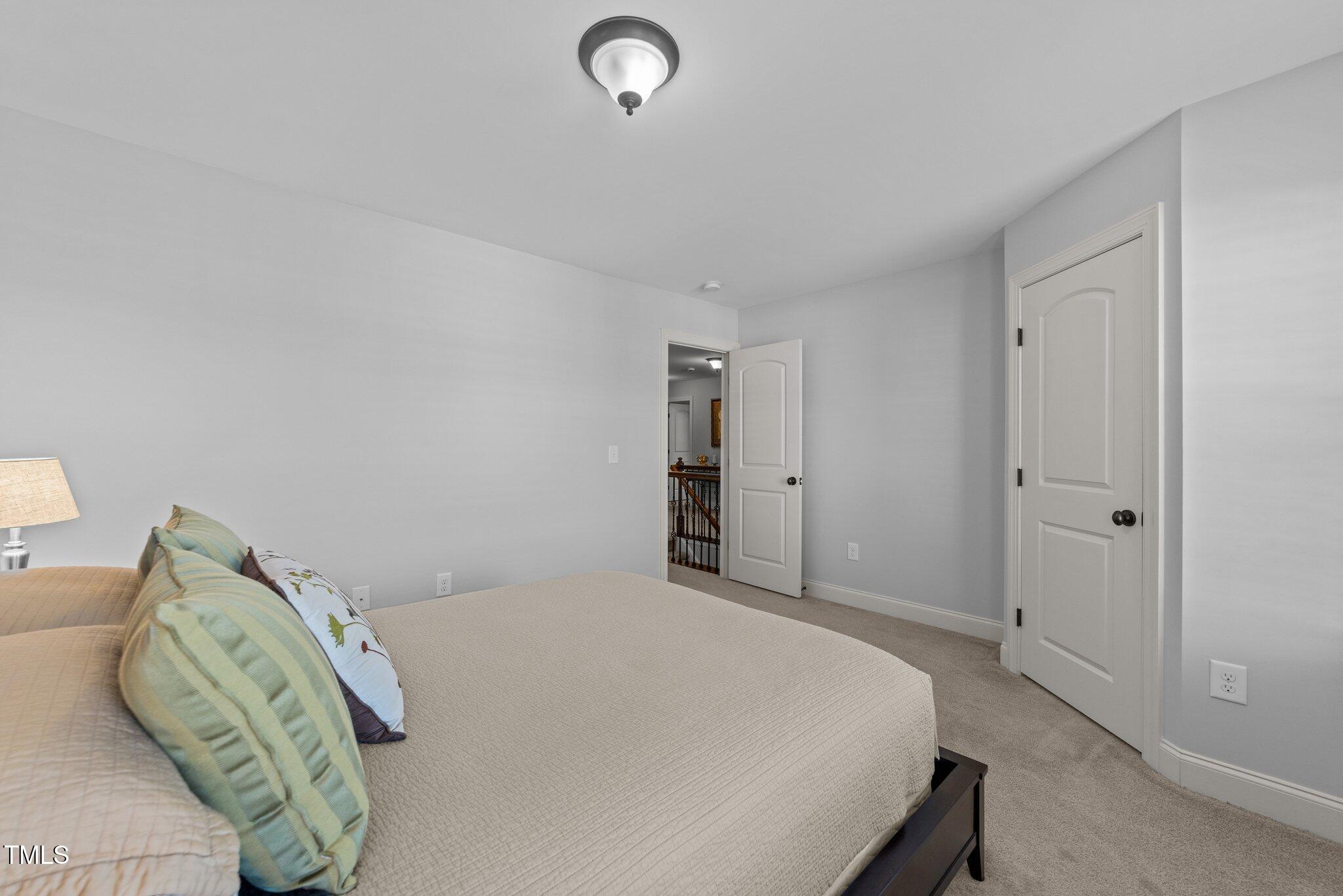 7520 Channery Way Raleigh, NC 27616 - Photo 34 of 47 a bedroom with a bed and a couch