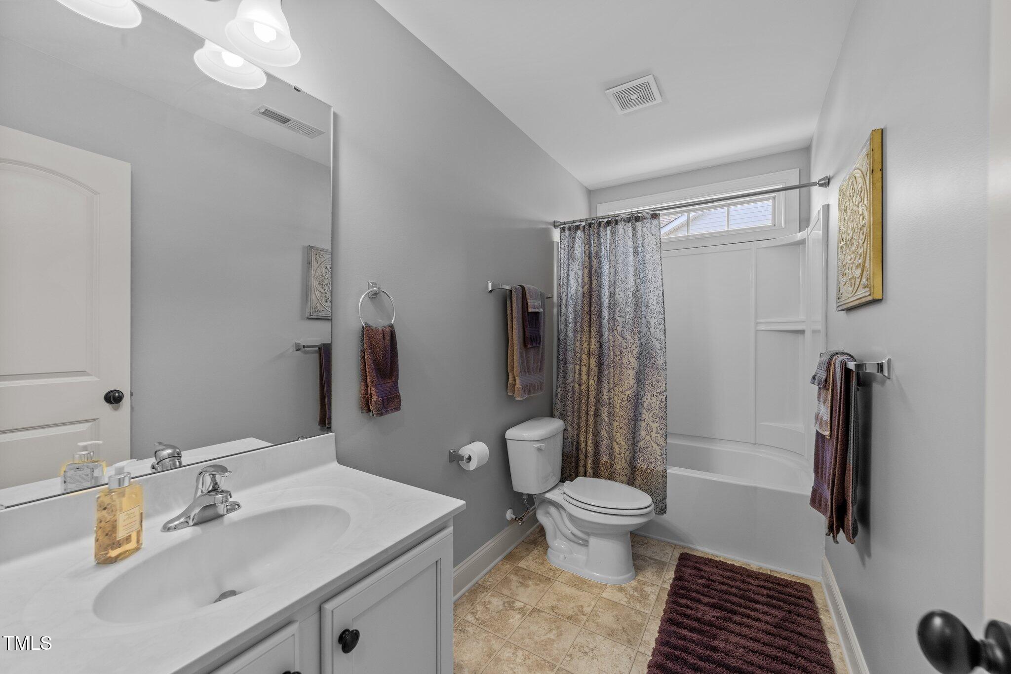 7520 Channery Way Raleigh, NC 27616 - Photo 35 of 47 a bathroom with a sink toilet double vanity and shower
