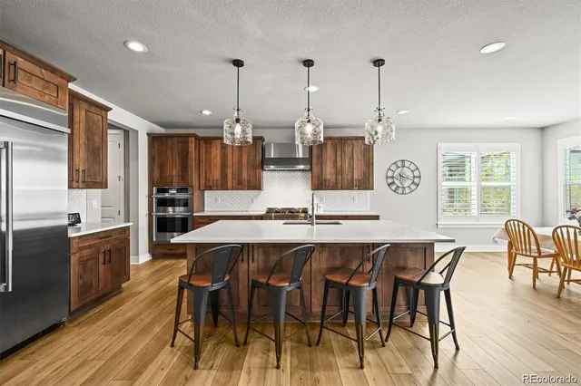a large kitchen with a table and chairs