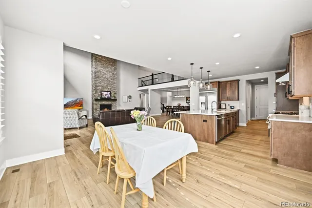 a large kitchen with a table and chairs in it