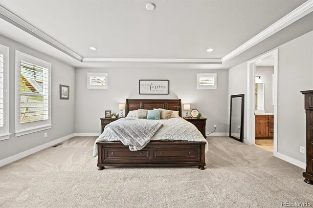 a spacious bedroom with a bed and a window