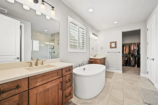 a spacious bathroom with a sink a bathtub and a mirror