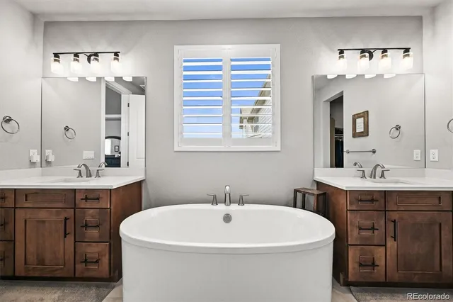 a white bath tub sitting next to a bathroom sink