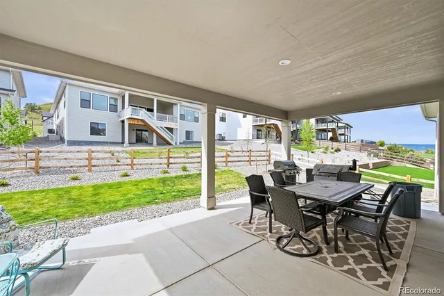 a view of a patio with a table and chairs