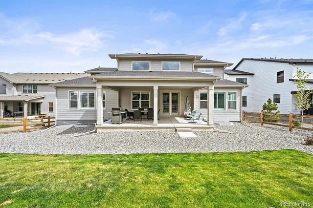 a view of a house with a backyard porch and furniture