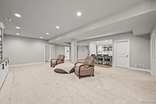 a living room with furniture and white walls