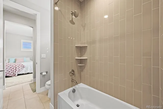 a bathroom with a tub shower and sink