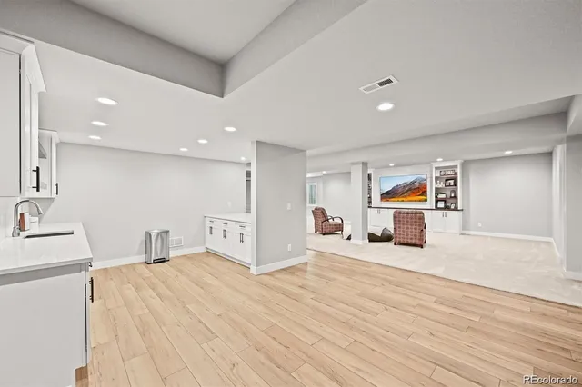 a large bedroom with a bed and a large mirror