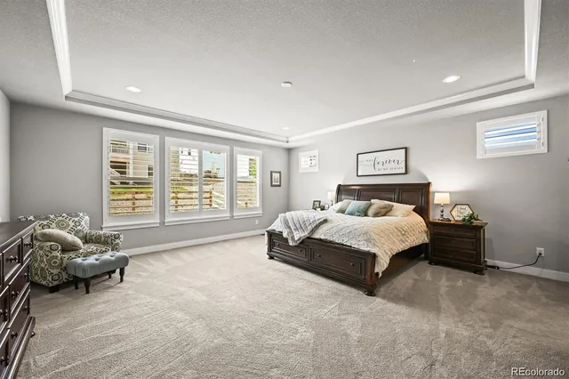 a spacious bedroom with a bed and glass window
