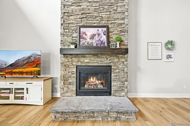 a living room with a fireplace and a wooden floor