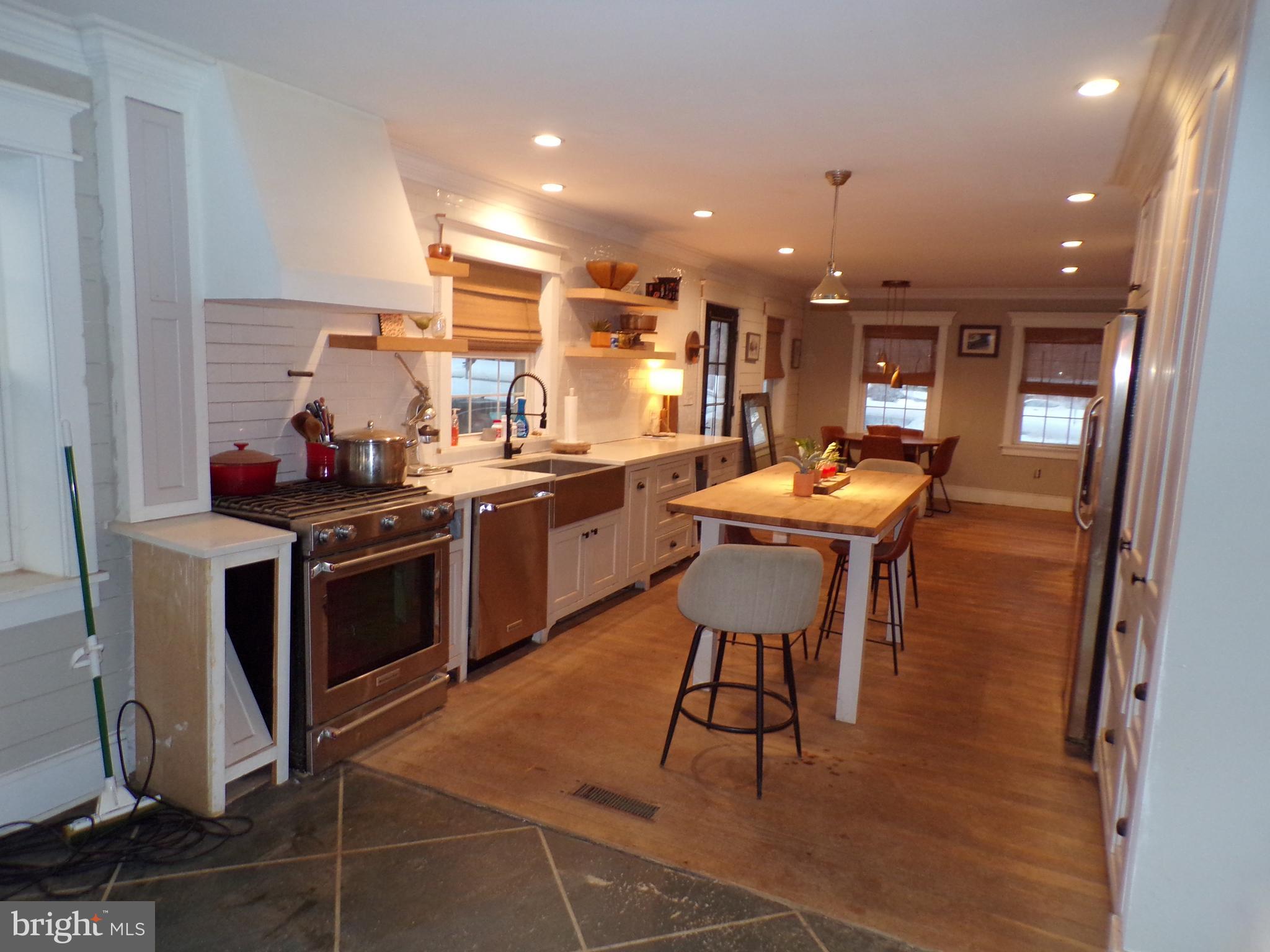 3316 Stoudts Ferry Bridge Road Reading, PA 19605 - Photo 9 of 18 a kitchen with a sink a stove and chairs